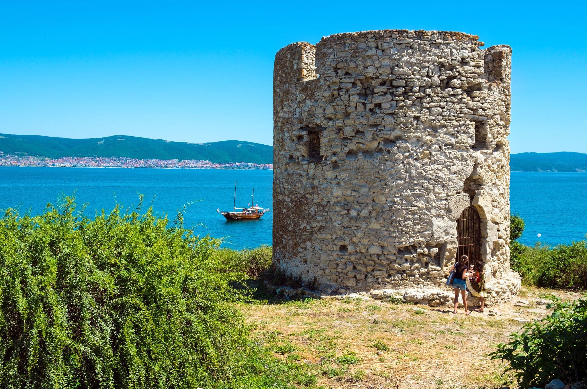 NESSEBAR, BULGARIA - JULY 3, 2014: The old watchtower of the ancient Bulgarian town Nessebar on the background of the resorts Sunny Beach and Saint Vlas.
