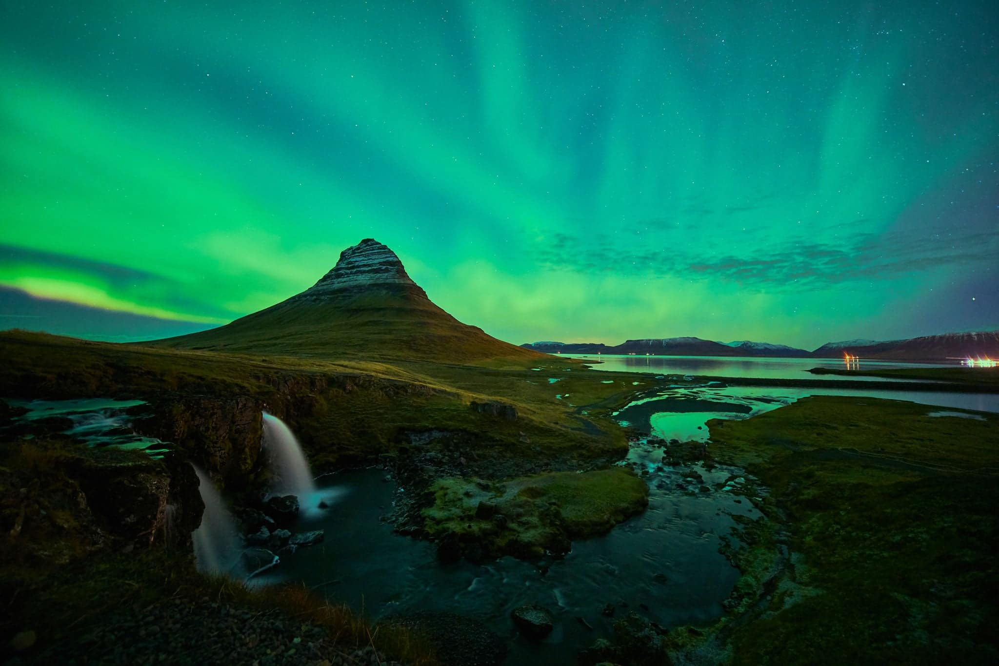 This beautiful northern lights or aurora borealis in Iceland was taken at or around Kirkjufell mountain and Kirkjufellfoss near Grundarfjordur during a winter night in November.