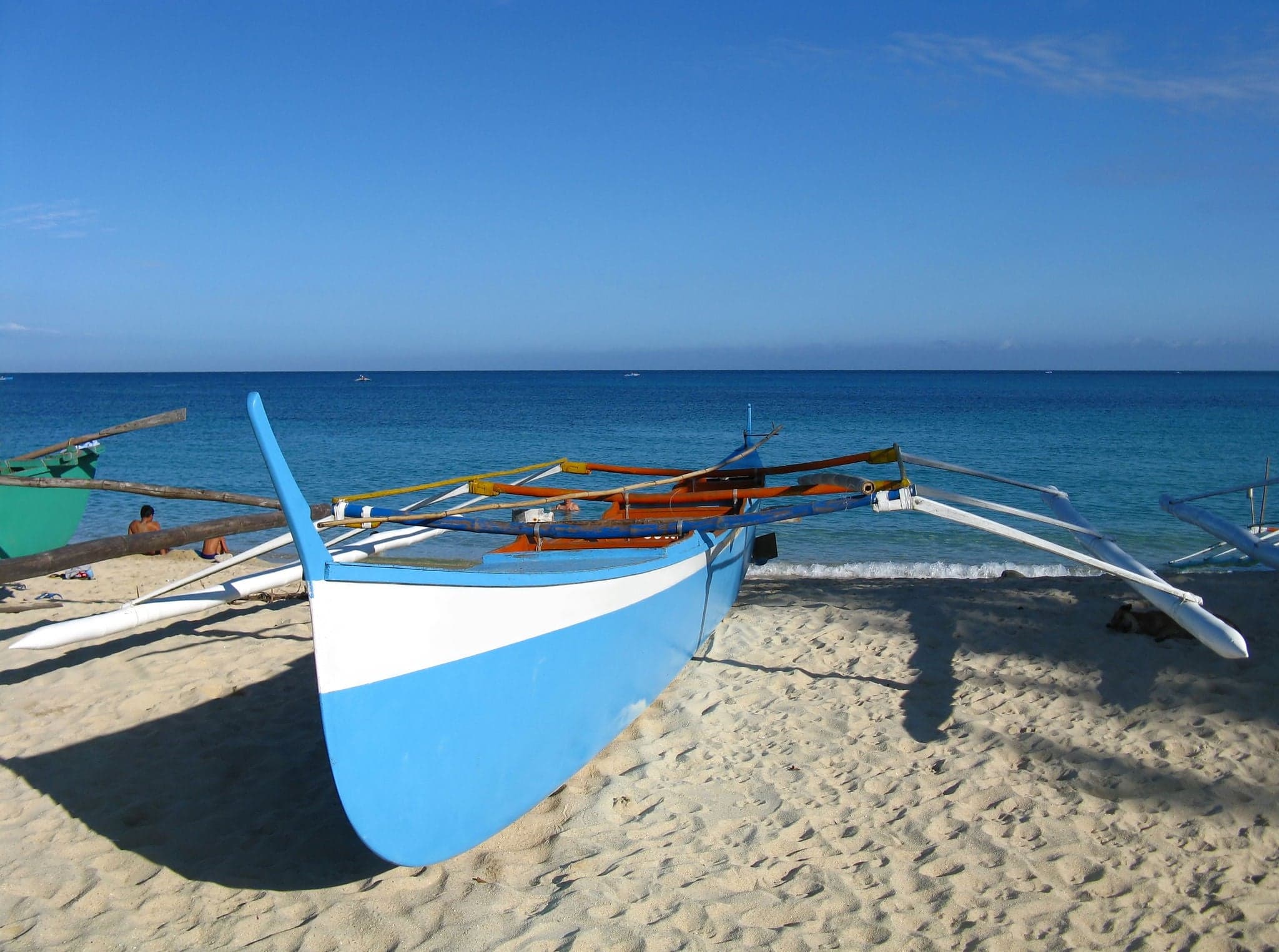 Blue fishing boat on the shore of Pagudpod, Ilocos Norte, Philippines