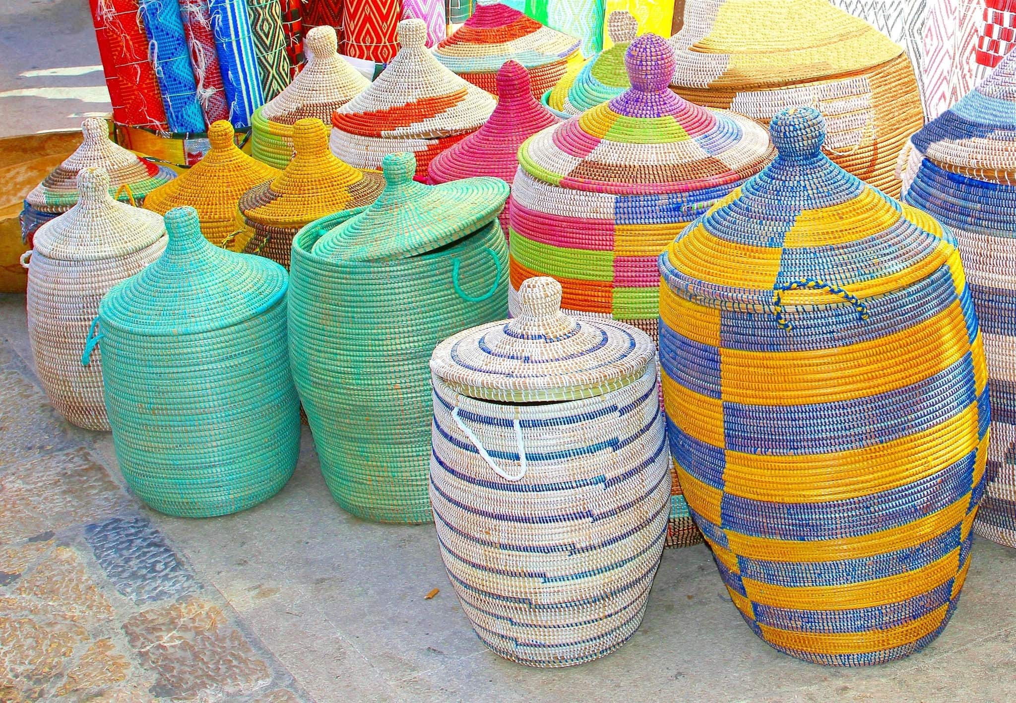 Collection of colorful woven wicker baskets, souvenirs made in Africa, small shop at flea market