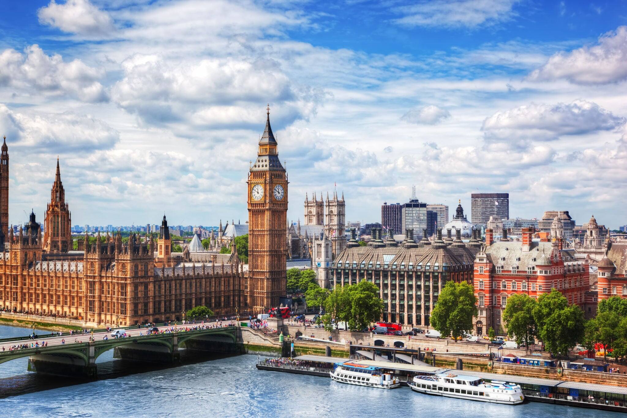 Big Ben, Westminster Bridge on River Thames in London, the UK. English symbol. Lovely puffy clouds, sunny day