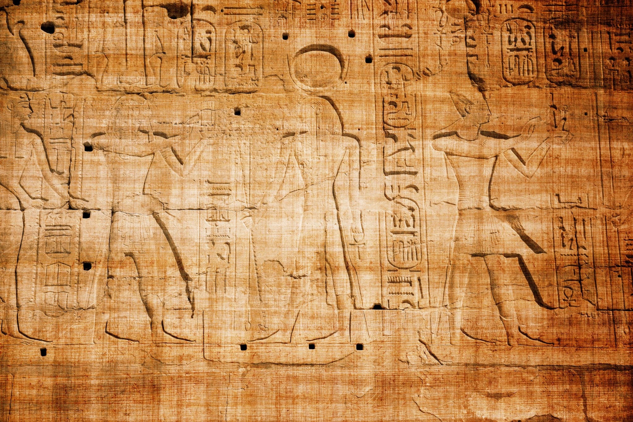 old egypt hieroglyphs carved on the stone with papyrus scratches