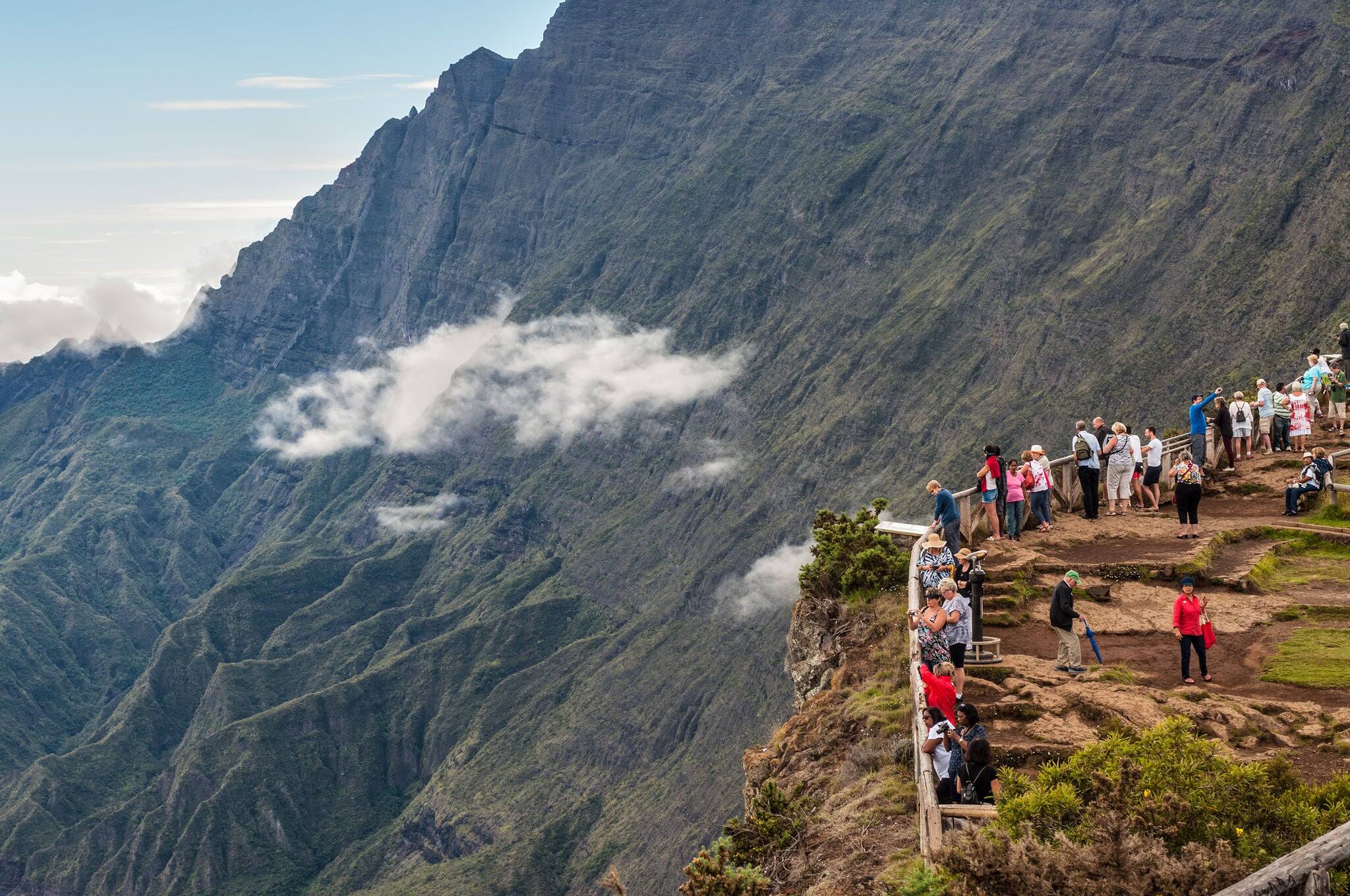 PITON MAIDO, LA REUNION ISLAND, FRANCE - DECEMBER 24, 2015: Tourists on the Maido lookout overlooking Cirque of Mafate, listed as World Heritage by UNESCO, La Reunion Island, France.