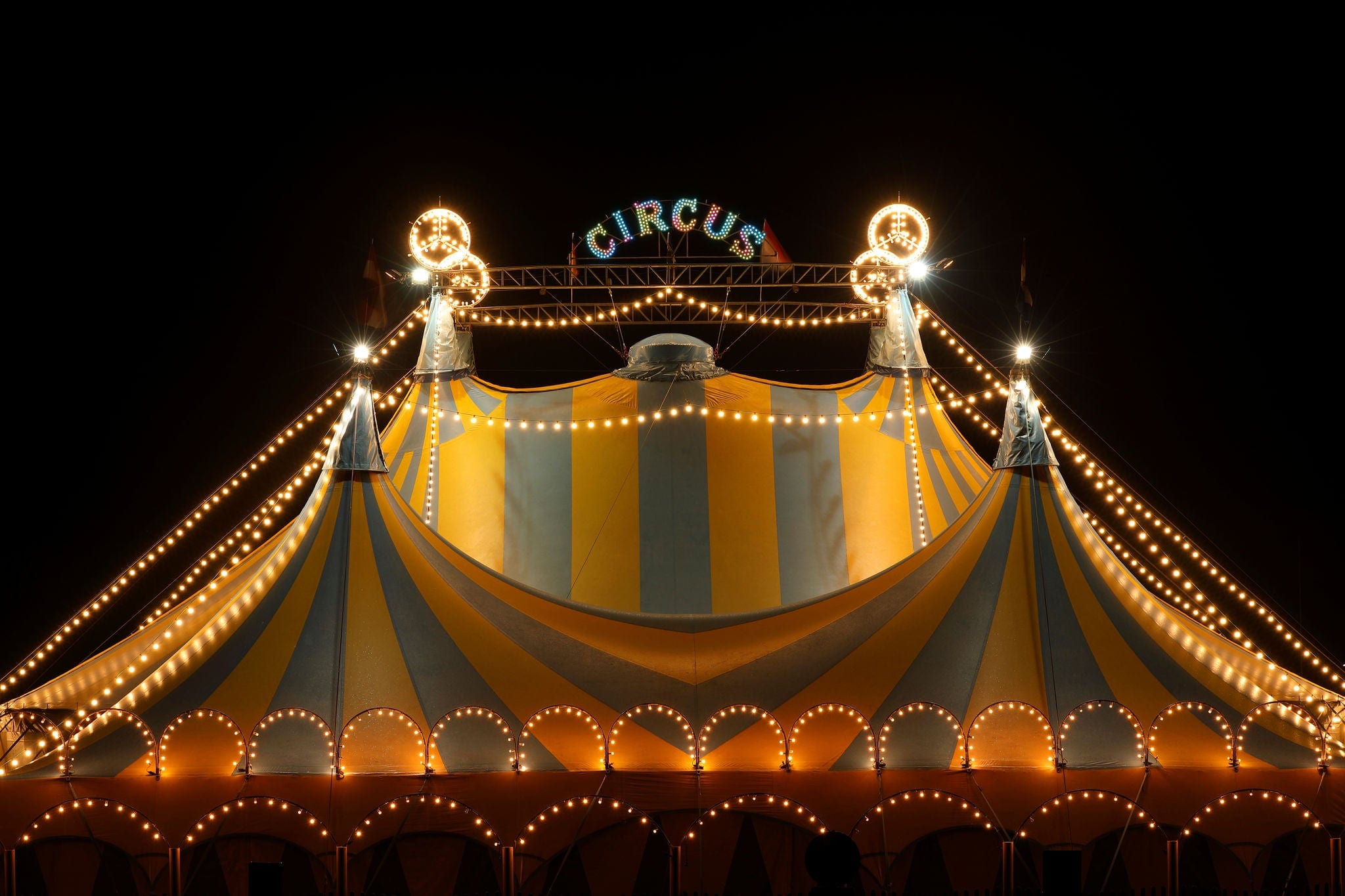 Circus tent at night with its colorful lights on