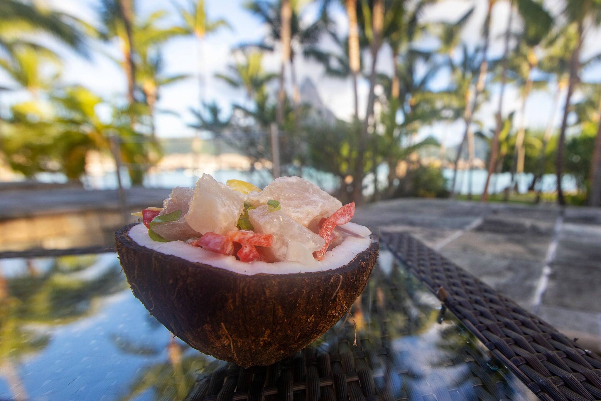 Fresh Poisson Cru raw fish served in a coconut shell