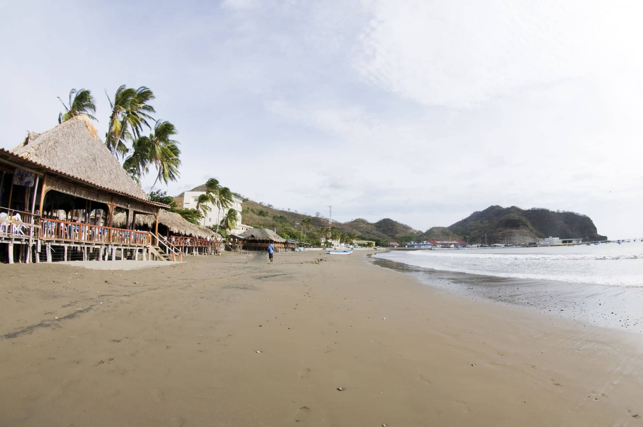 beachfront scene san juan del sur nicaragua with thatched roof restaurants and hotels on pacific ocean