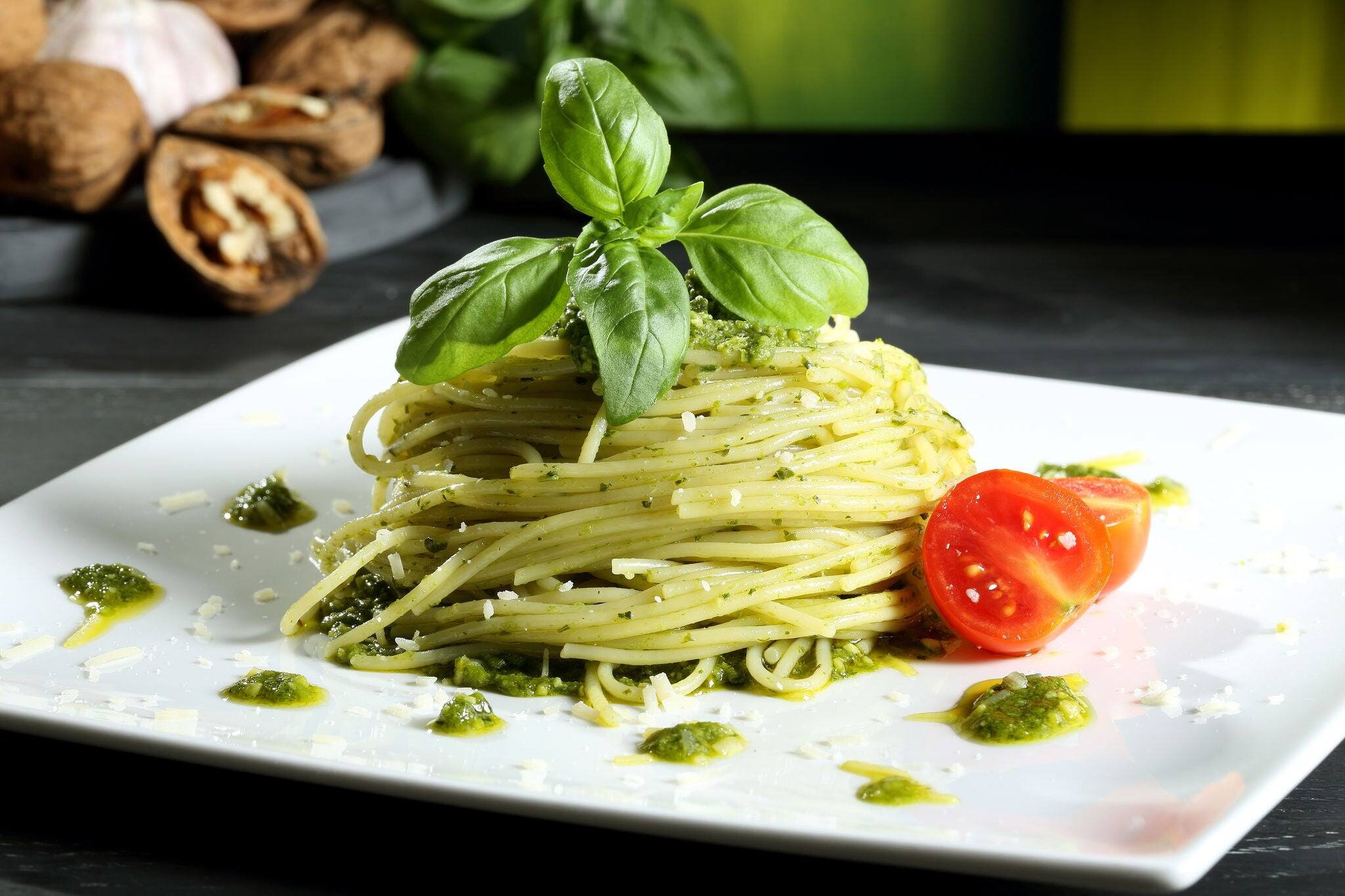 pasta spaghetti with pesto  genovese green background