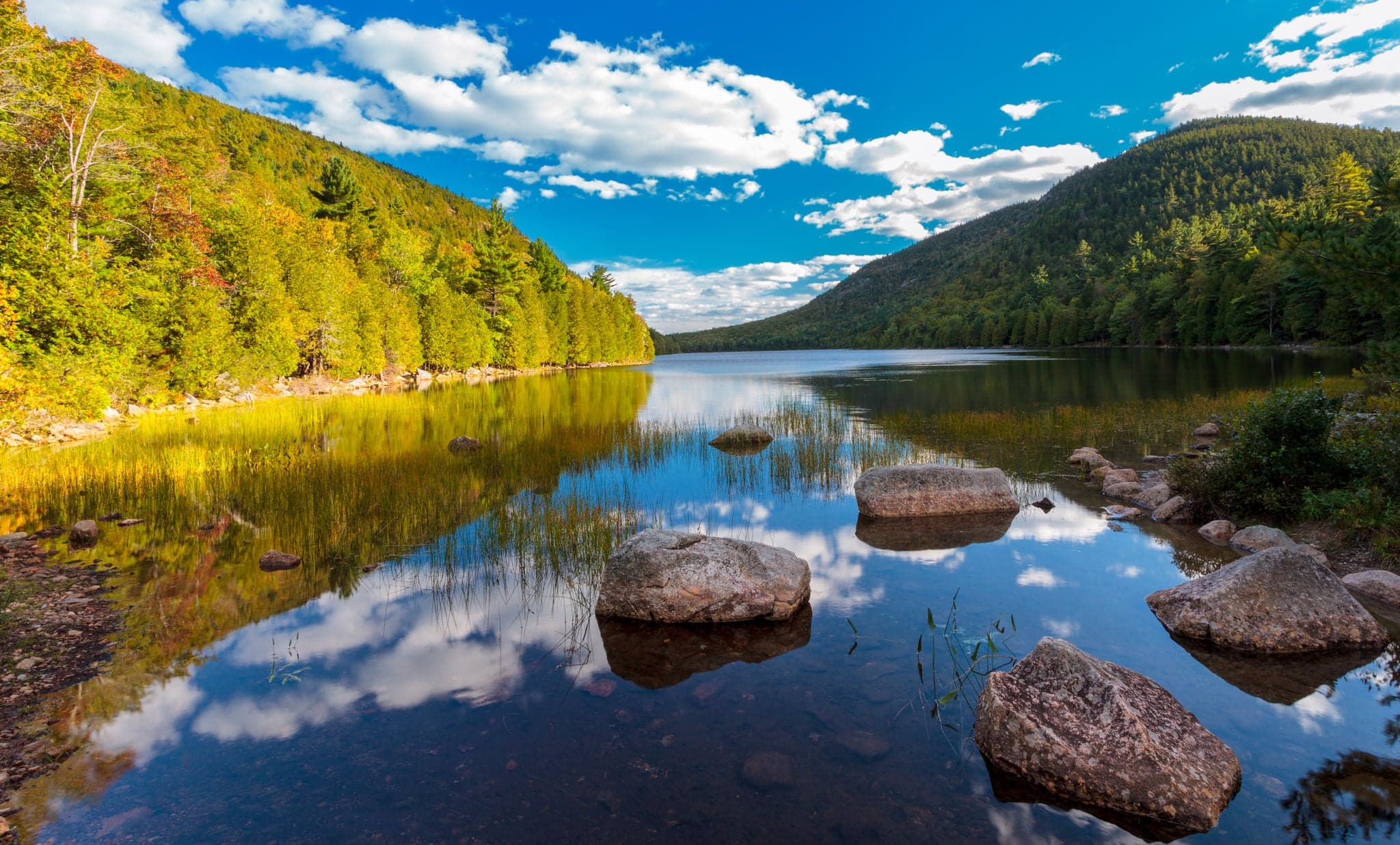 peaceful pond in Acadia national park, blue cloudy skies and morning light