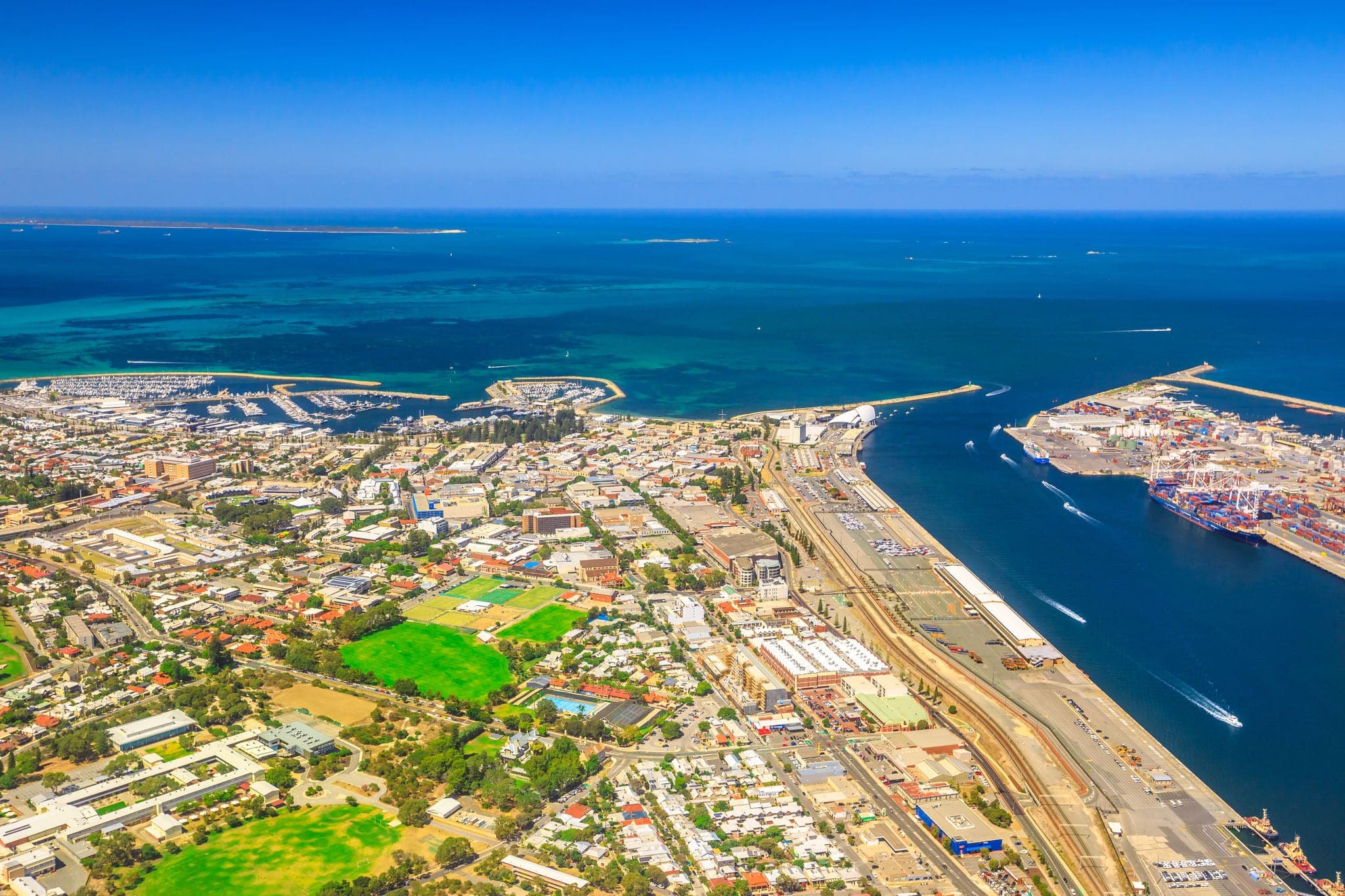 Aerial view of Fremantle Harbour, the Western Australia's largest and busiest general cargo port. Scenic flight over Fishing Boat Harbour, North Mole Lighthouse and Swan River, Australia. Copy space.