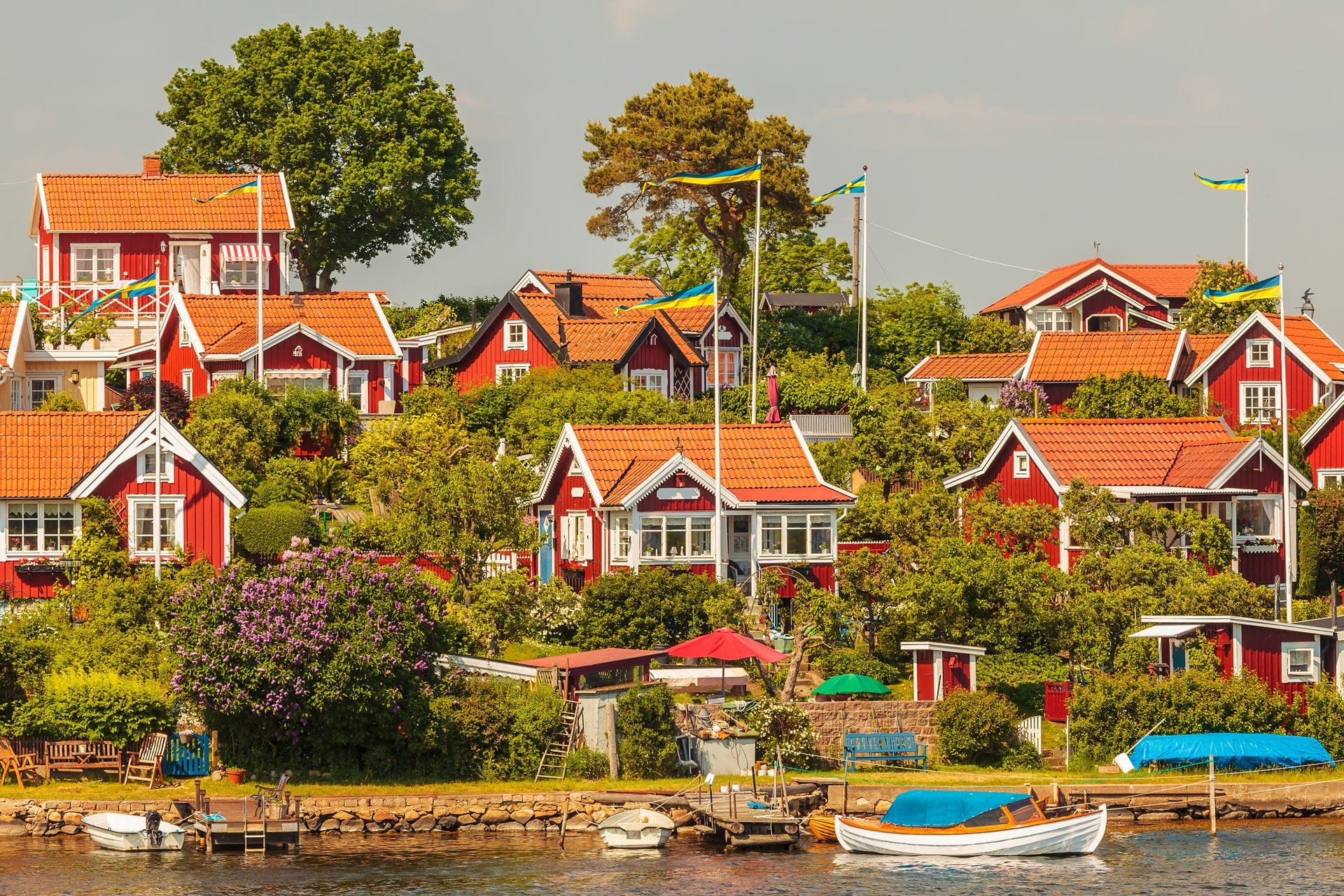Typical red Swedish wooden houses with boats in the city of Karlskrona.