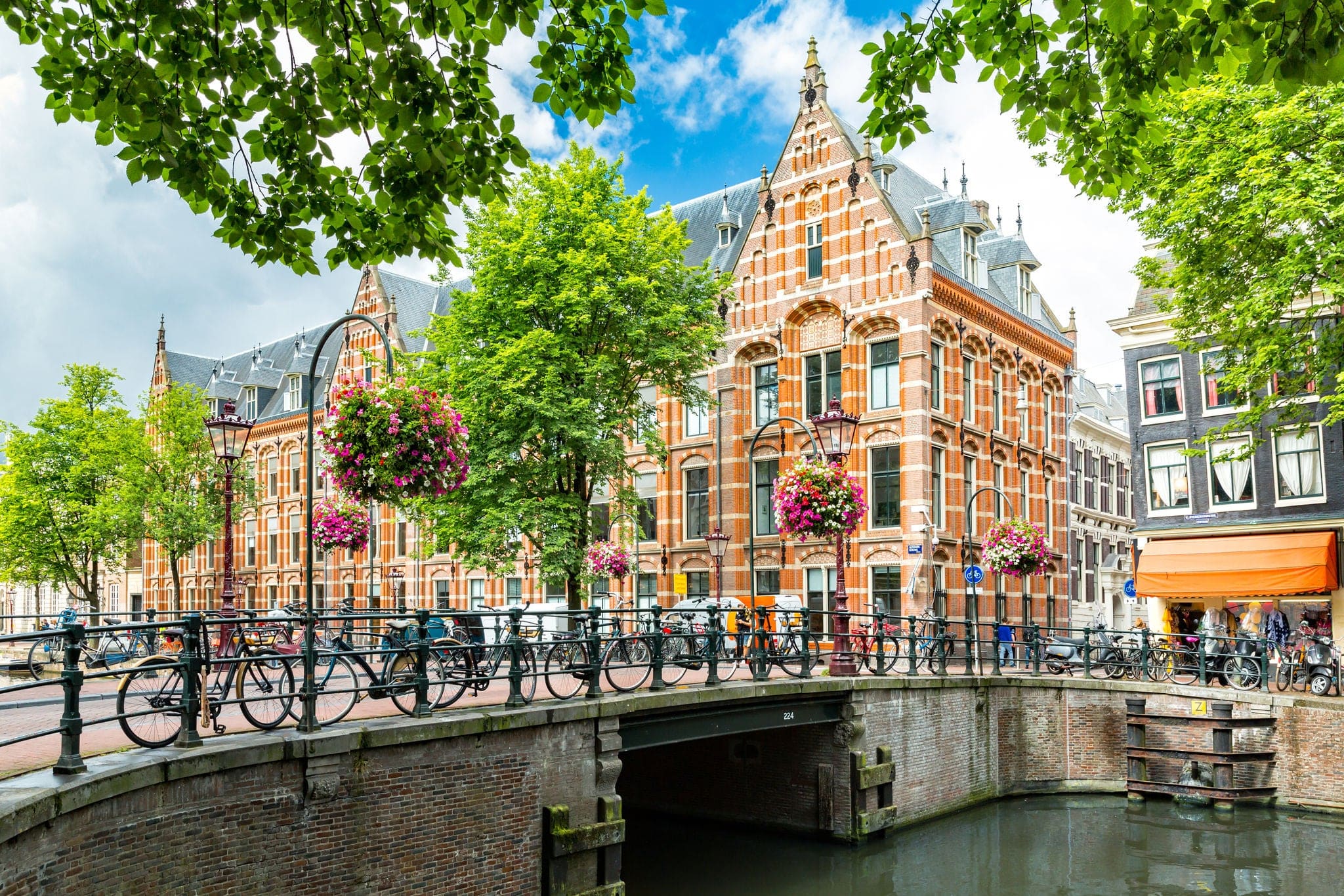Typical canal side cityscape of Amsterdam, opposite from the 17th century HQ of the Dutch East India Company, now used by the University of Amsterdam