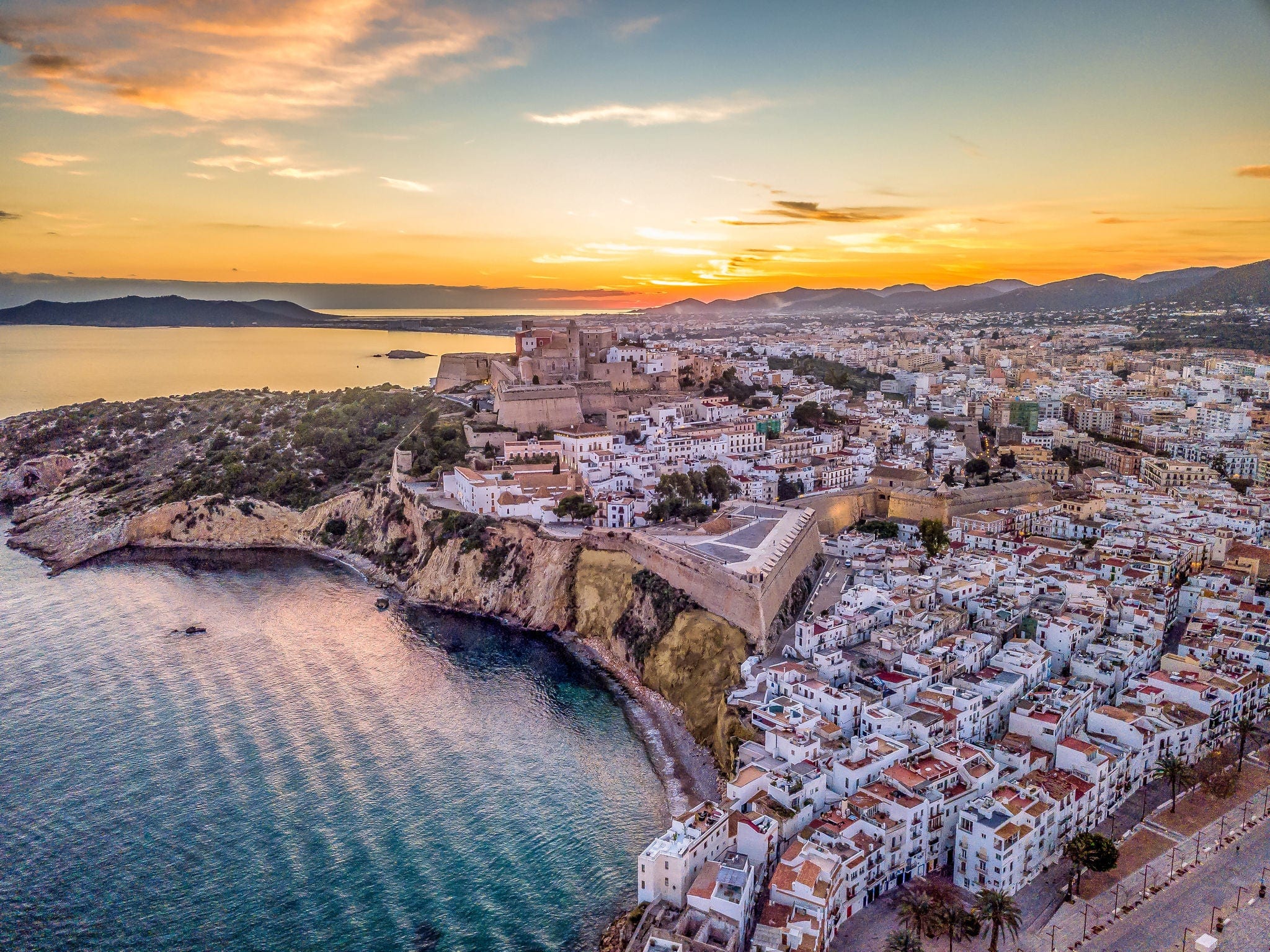 Aerial view of stunning sunset over Ibiza (Evissa) during a winter evening with view of the medieval fortress and the old town