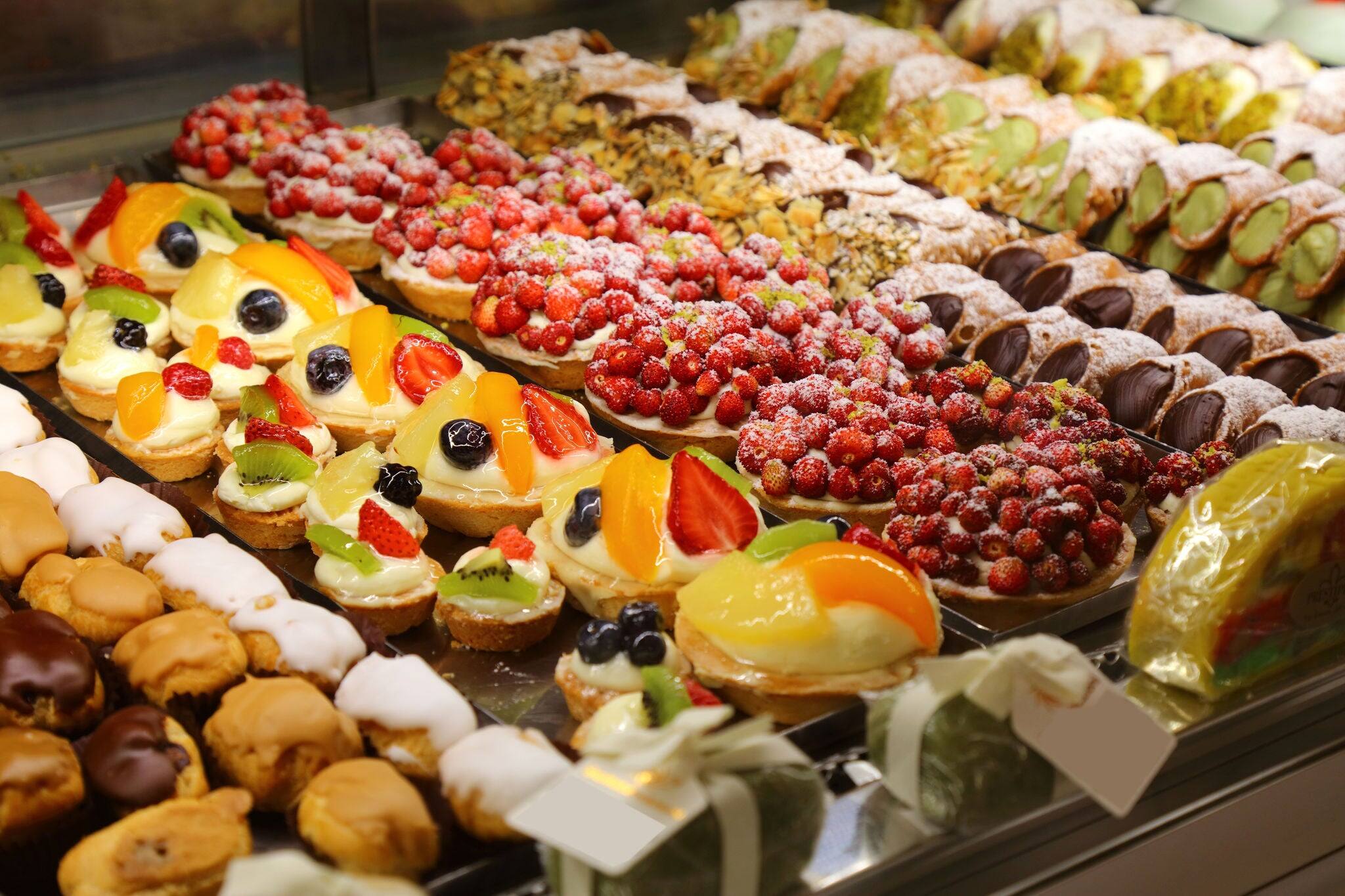 Sweets of Catania, Sicily. Italian pastries: profiteroles, fruit tartelettes and cannoli.