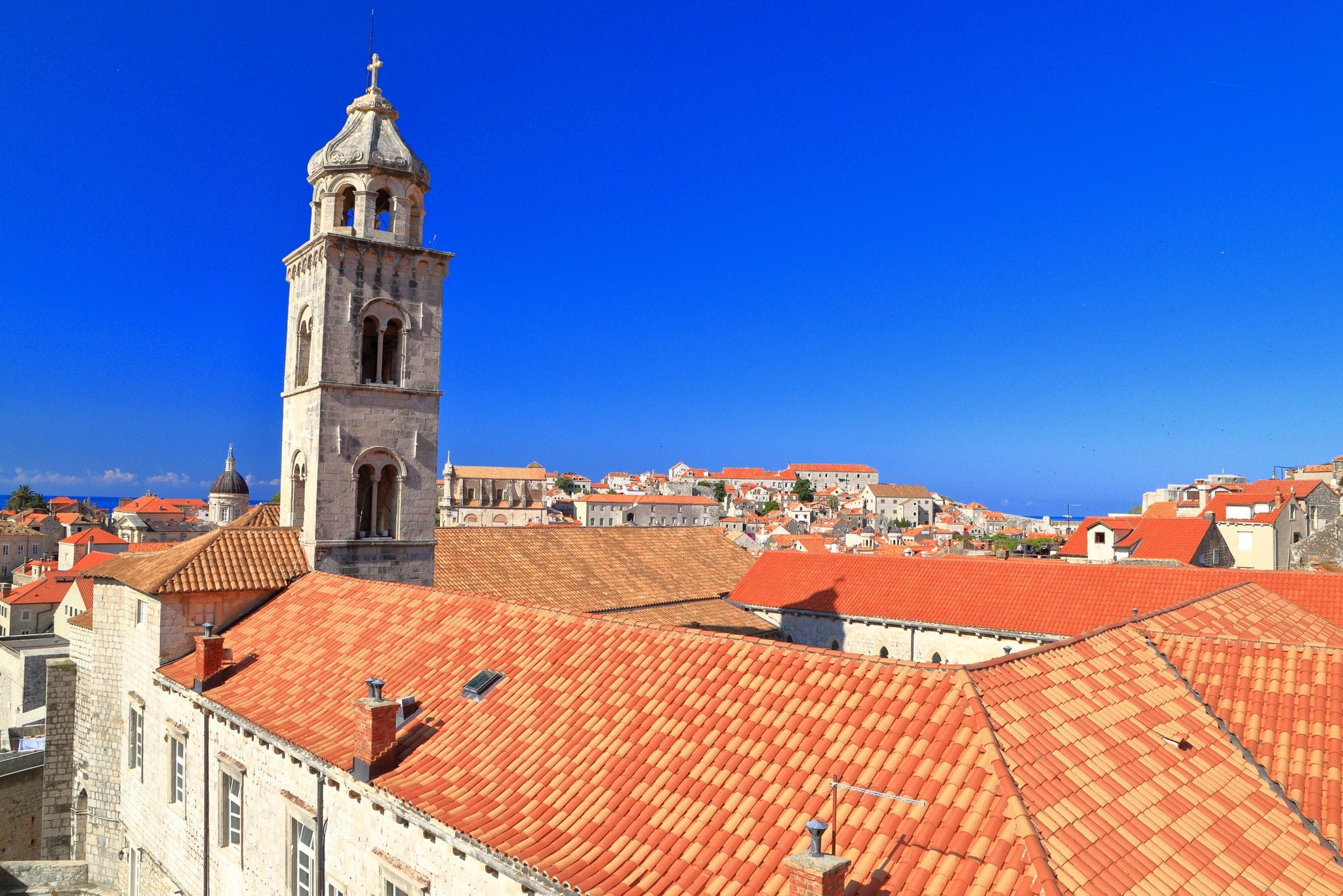 Old town of Dubrovnik with church tower above orange roof tops, Croatia