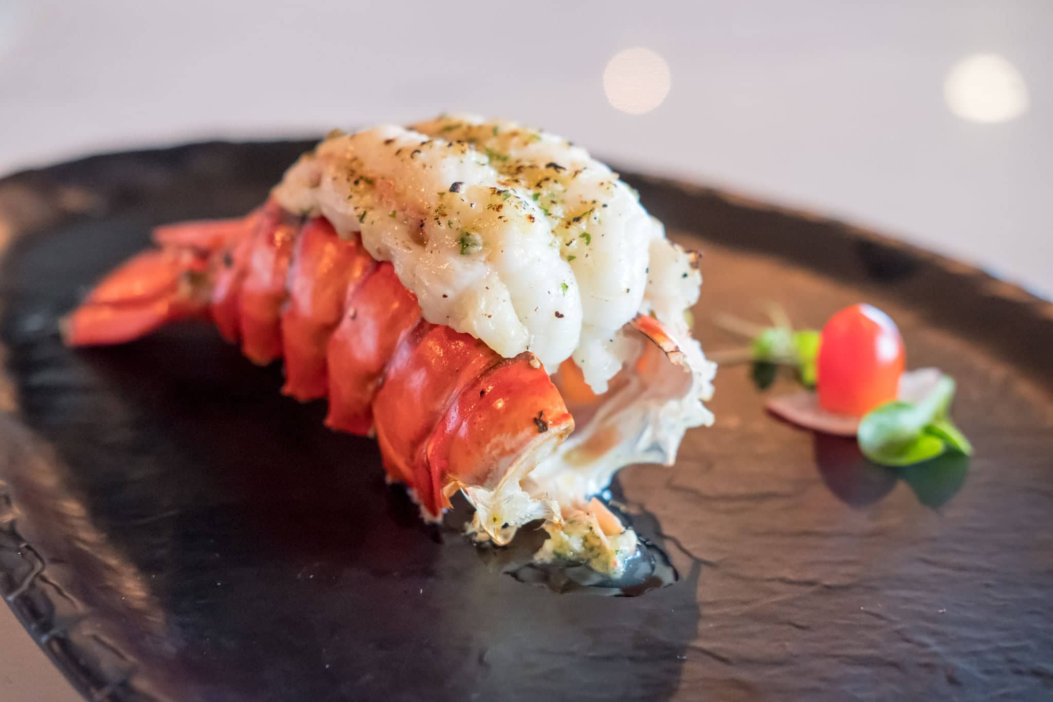 Grilled Lobster and vegetables on plate.