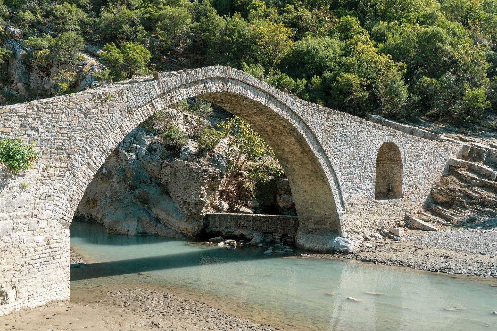 Arch shaped stone bridge in Albania on the hot springs of Benje. this bridge is build by the ottomans a long time ago. the location is at the thermal pools on the town of Permet