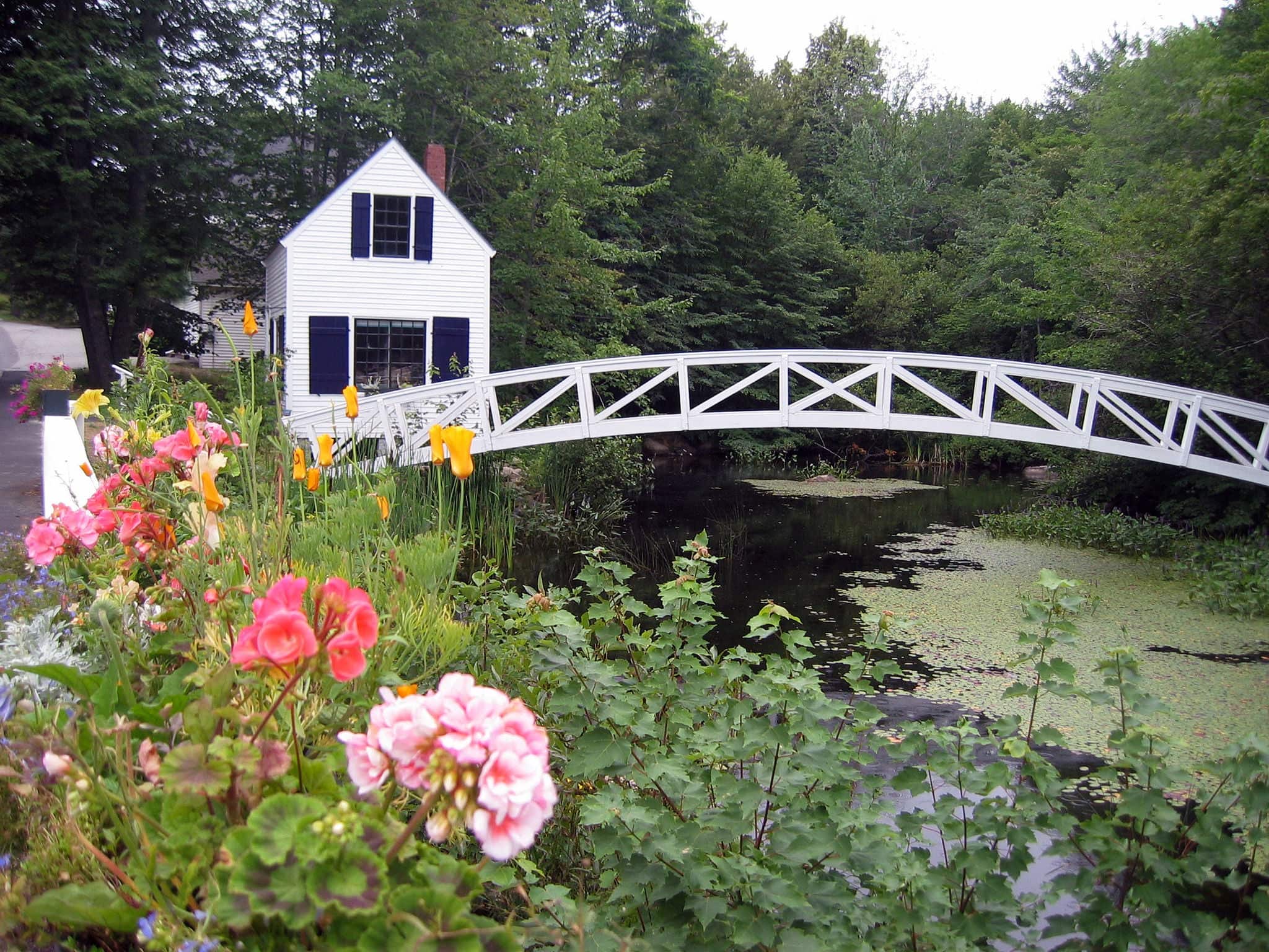 Quaint house by Somes Pond Maine with arched walking bridge
