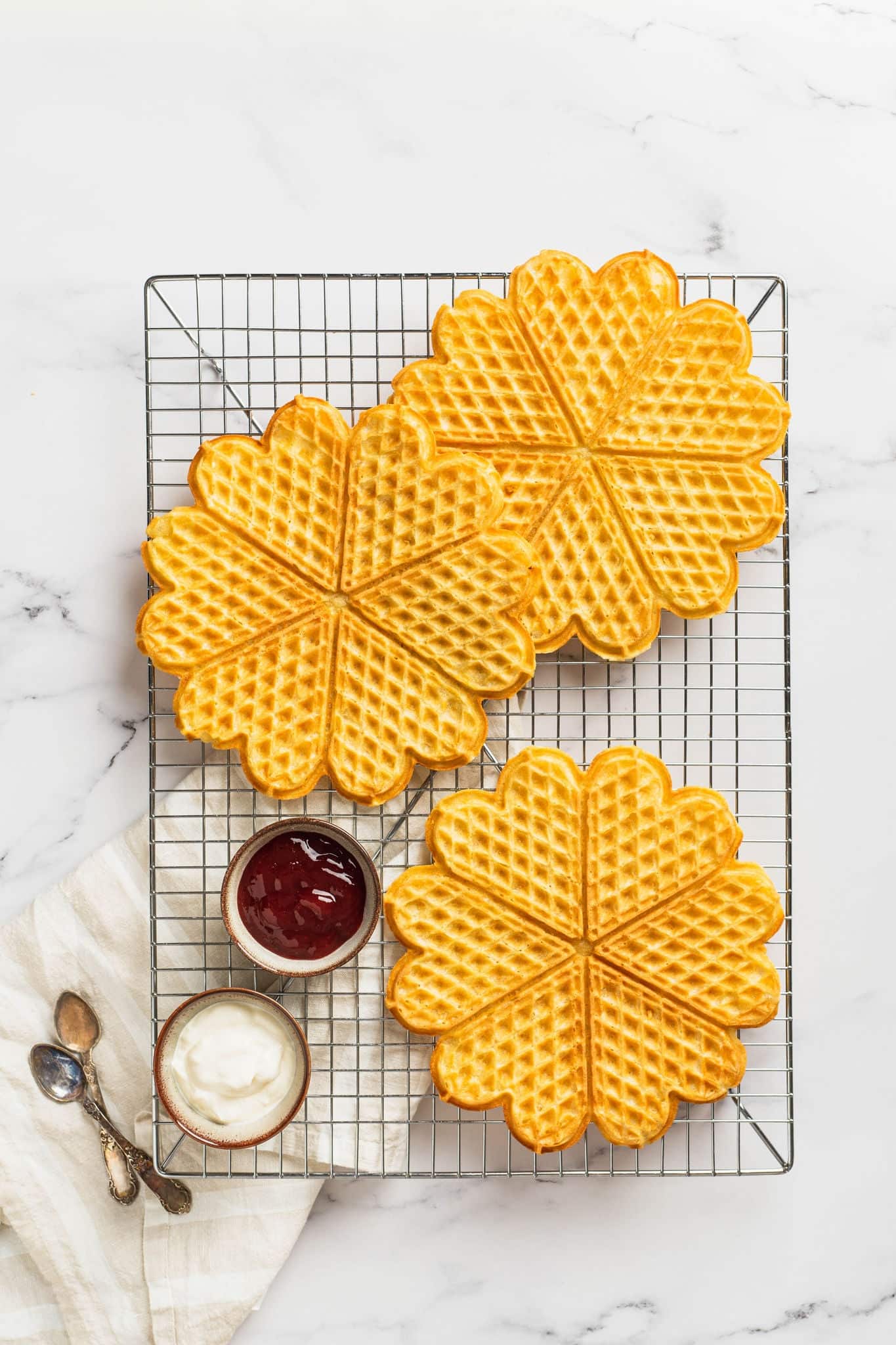 Norwegian heart shaped waffles with sour cream and jam. Waffle day. Scandinavian traditional food. baked waffles