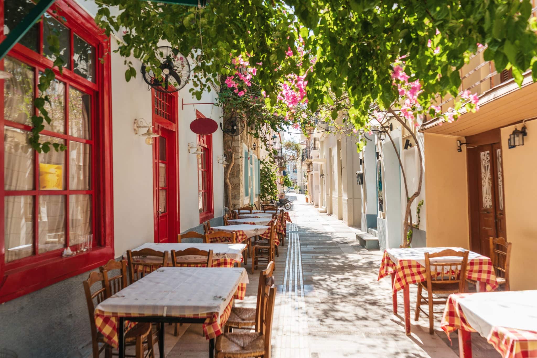 The cozy Greek city of Nafplion in the summer, blooming streets and restaurants. The first capital of Greece.