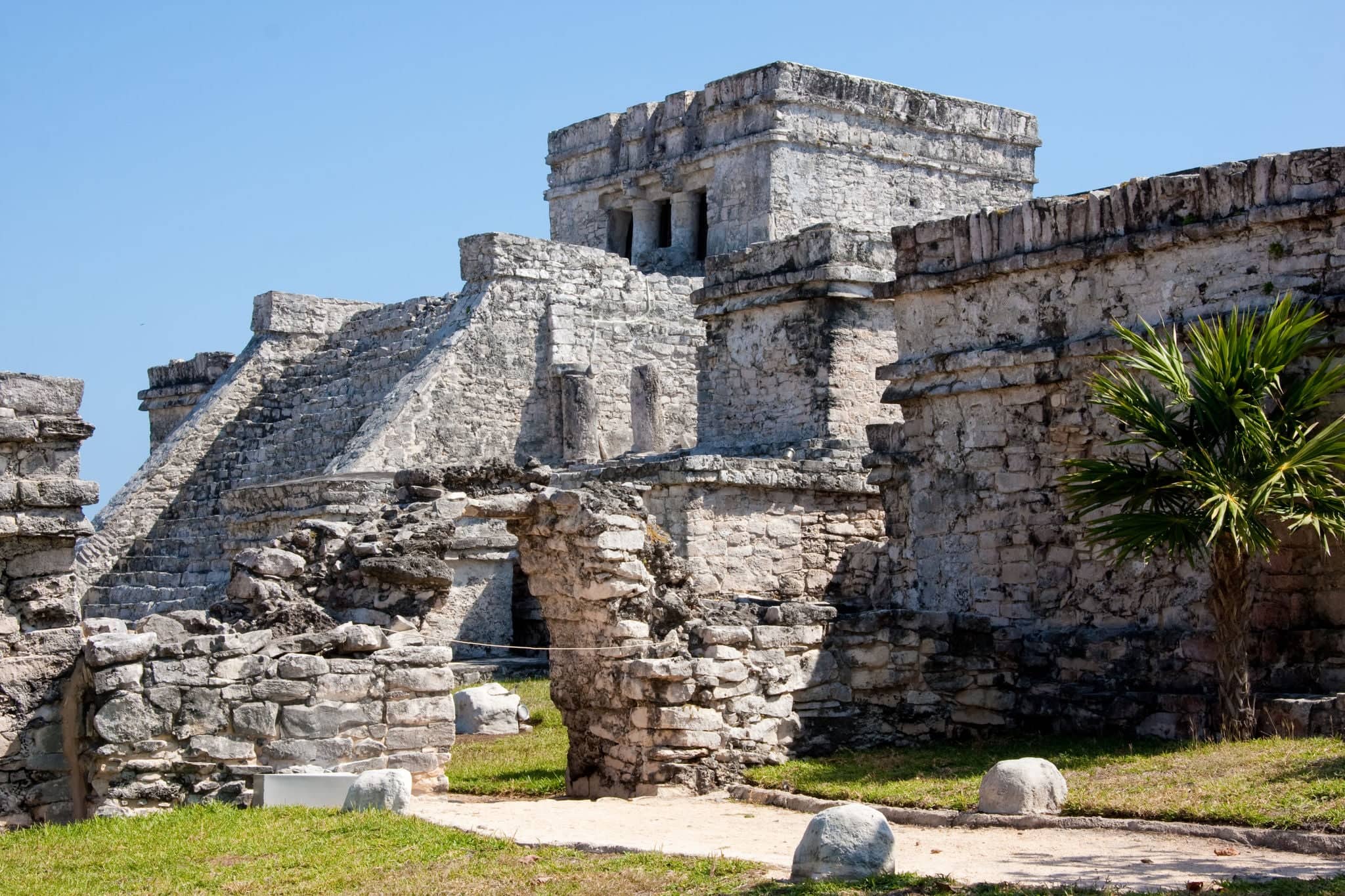 Tulum is one of the best-preserved coastal Maya sites and a popular site for tourists.  El Castillo (the castle), a temple with two columns portraying serpents.