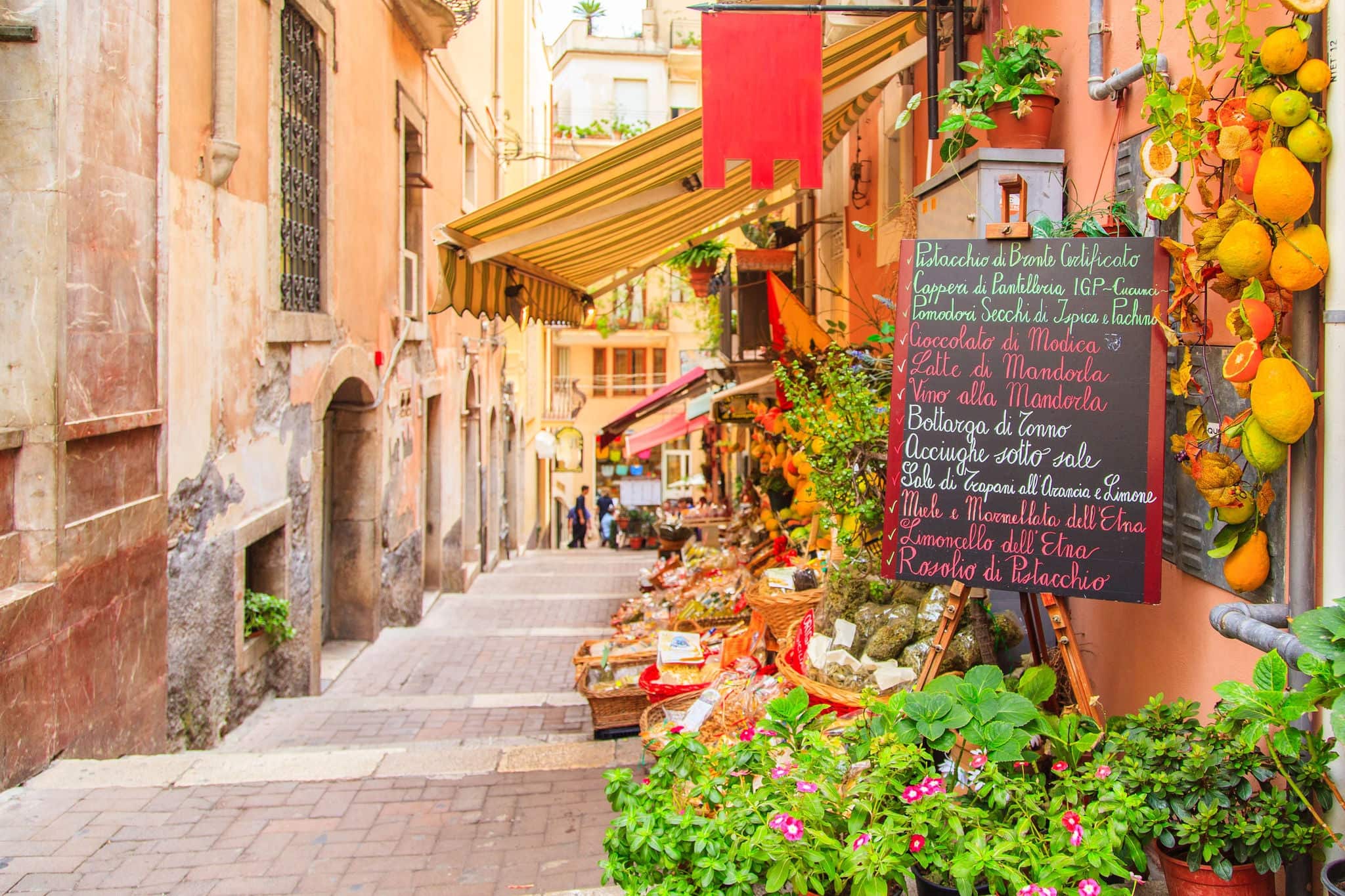 Entrance to local shop in Taormina, Sicily. Writing on the black table lists itmes on promotion.