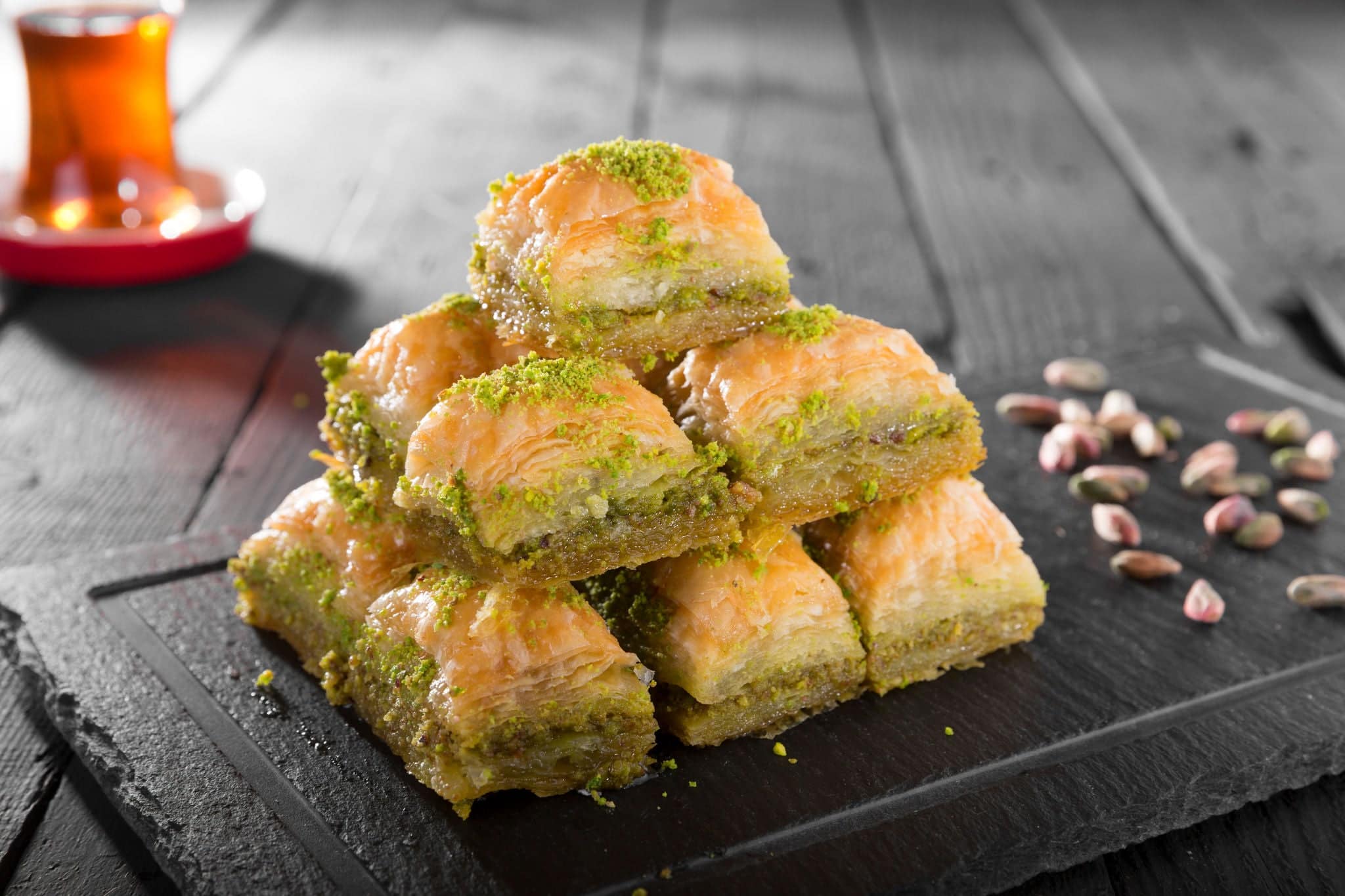Turkish ramadan dessert Baklava with pistachio and black arabian tea.