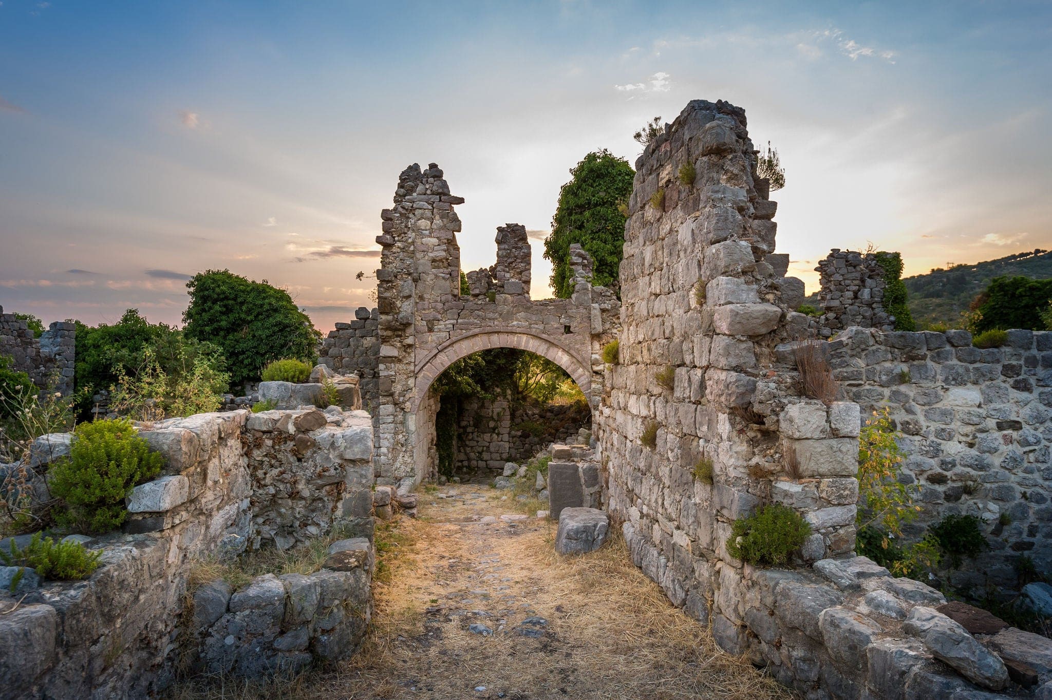 Ruins of Stari Bar ancient fortress, arch way to ruined defense tower, Montenegro.
