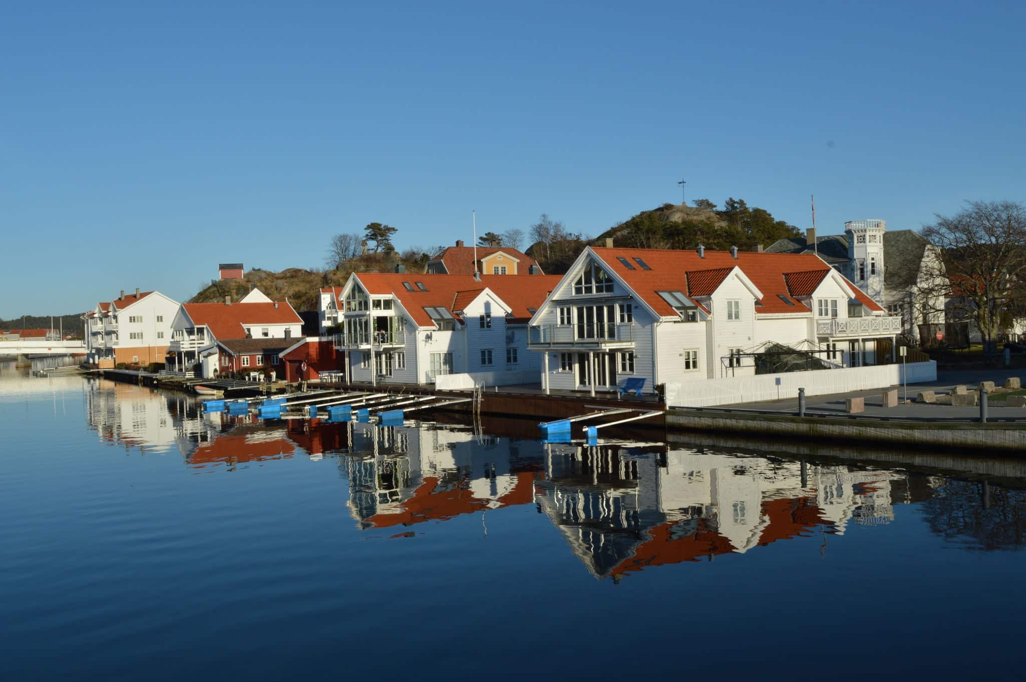 Photo of typical Norvegian houses near Marna river in small city Mandal Norway
