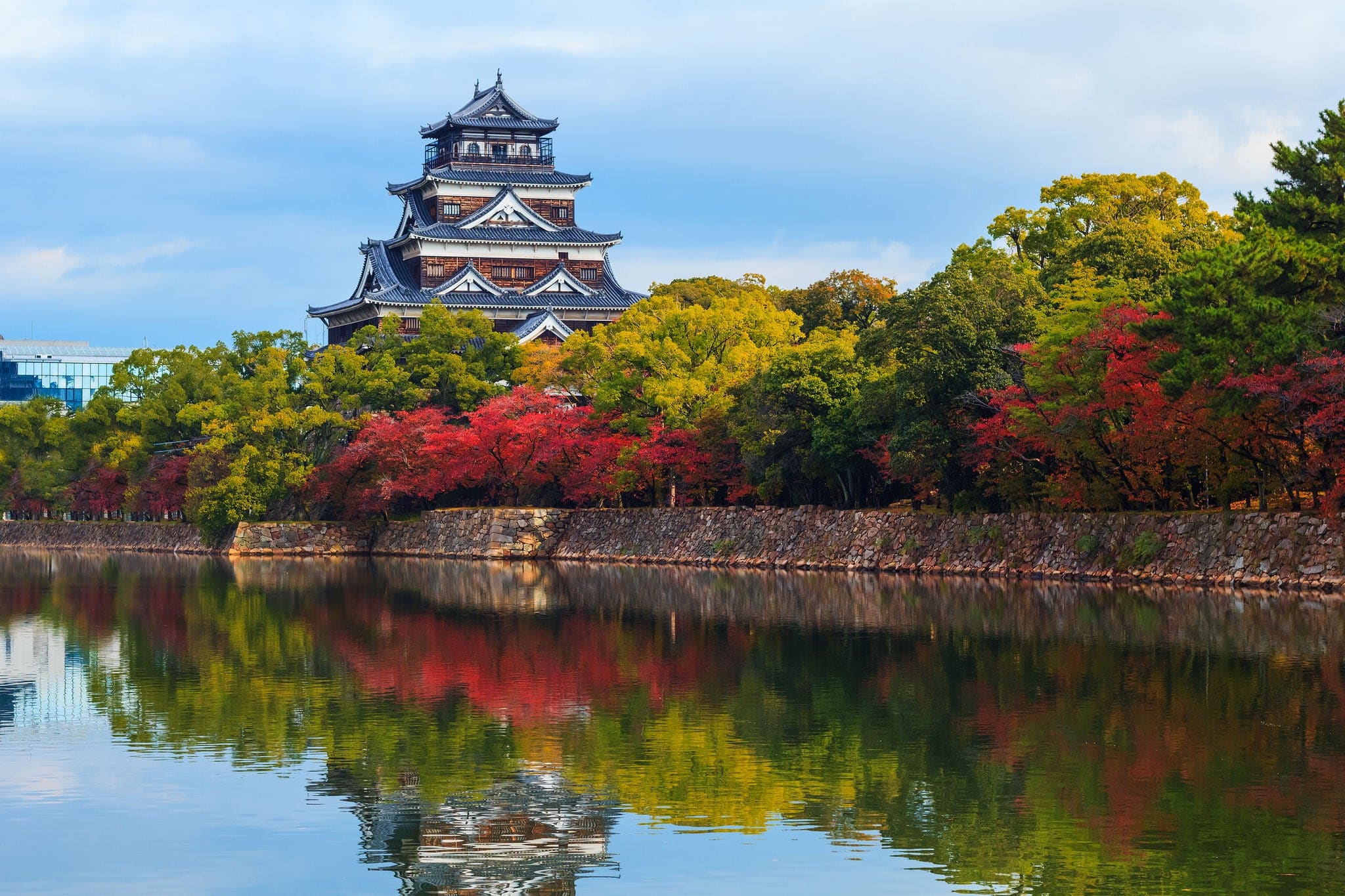 Hiroshima castle on the side of Otagawa river in autumn