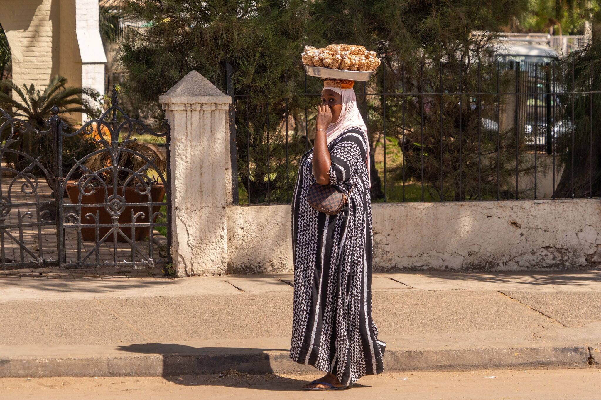 woman selling peanuts in the capital of Gambia, Banjul, traditional activity, traditional dress, Africa
