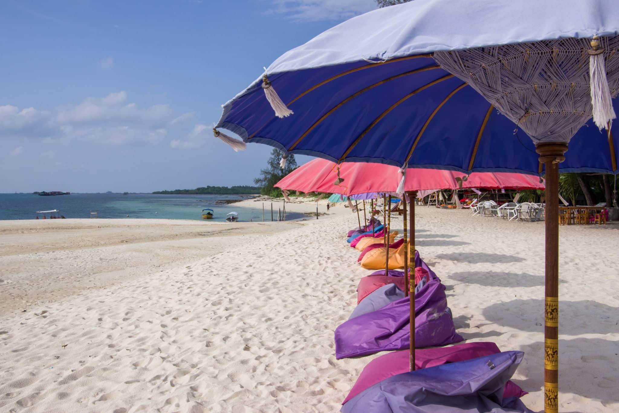 Sunny Day on the Beach with Chairs/Beds and Umbrellas on the White Sands Island, Bintan, Indonesia