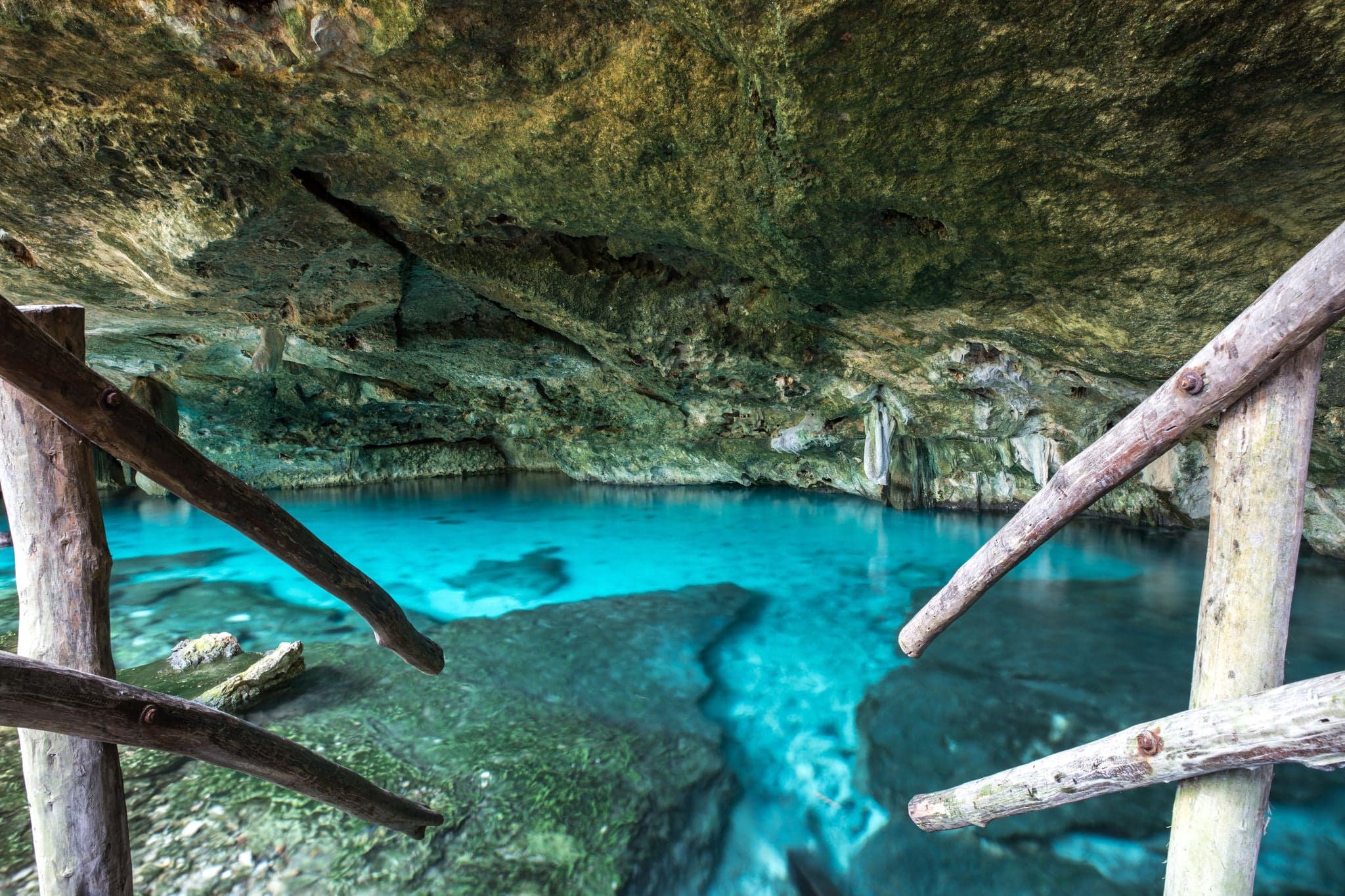 Bright blue cenote - underground waterhole in a lime stone cave. Tulum, Mexico.