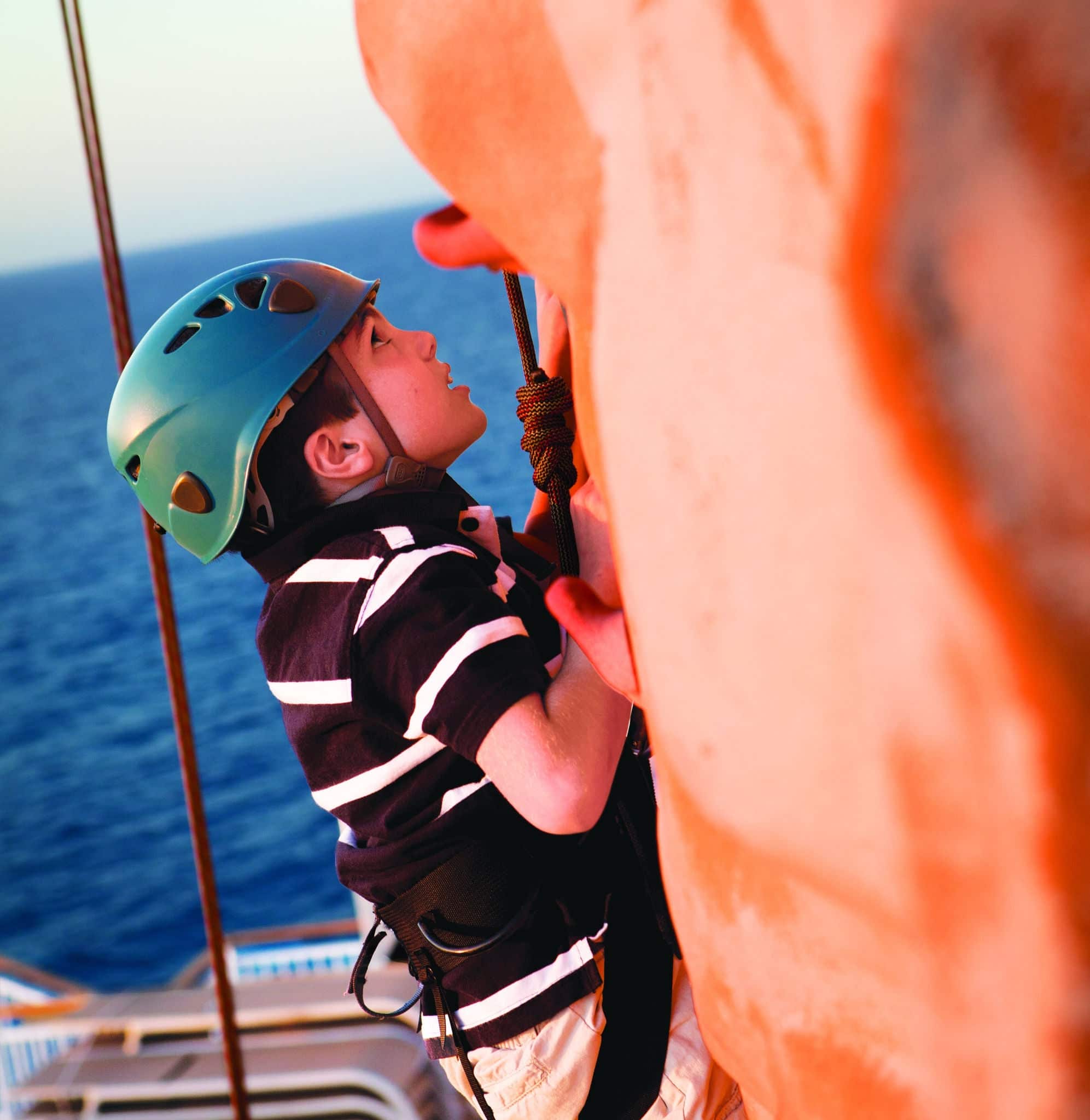 Boy climbing rock wall
