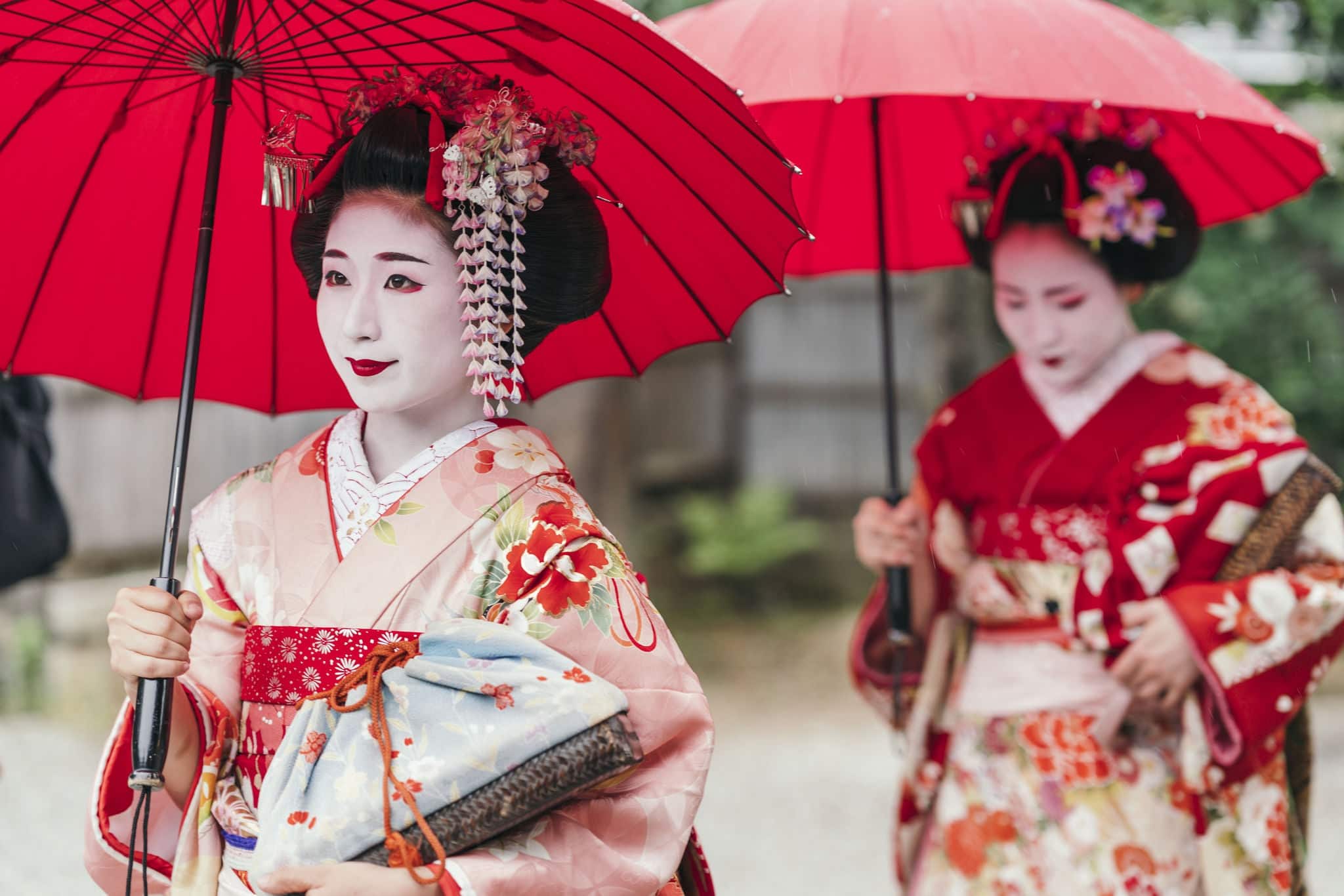 Maiko geisha walking on a street of Gion in Kyoto Japan