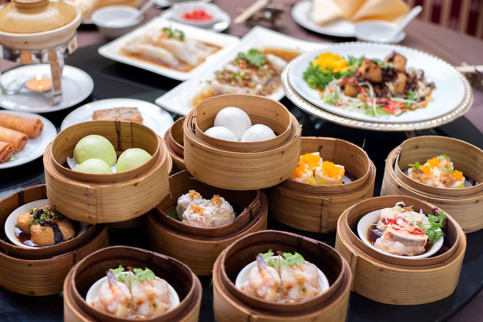 yumcha,The Arrangment of various dim sum in bamboo steamer with chinese bun , pao , bao zi , steamed dumpling , shumai on table in chinese restaurant