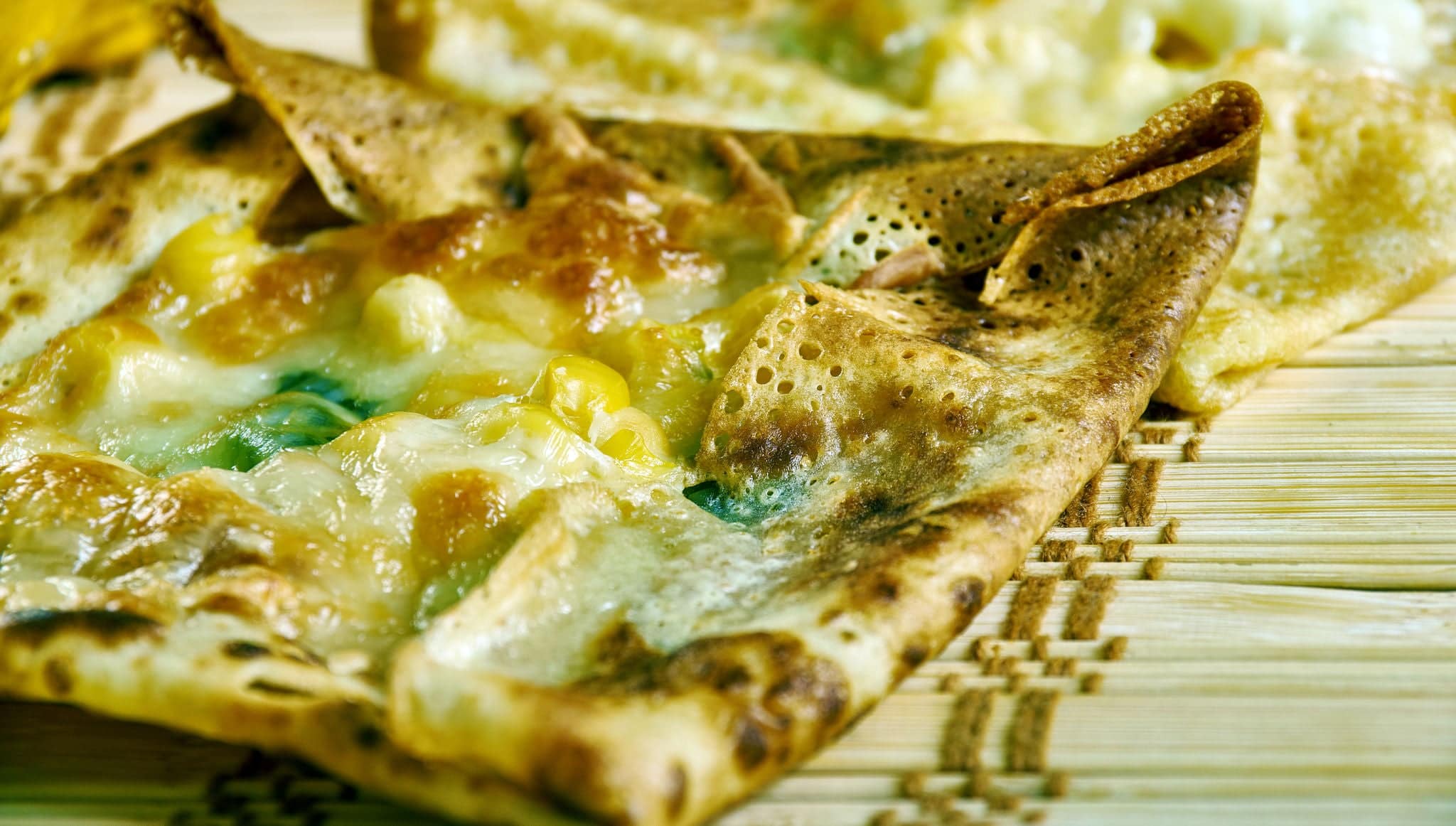 Zanzibar pizza, crispy pancakes with as many meats, sweets, or vegetables , Tanzanian cuisine, Traditional assorted African dishes, Top view.