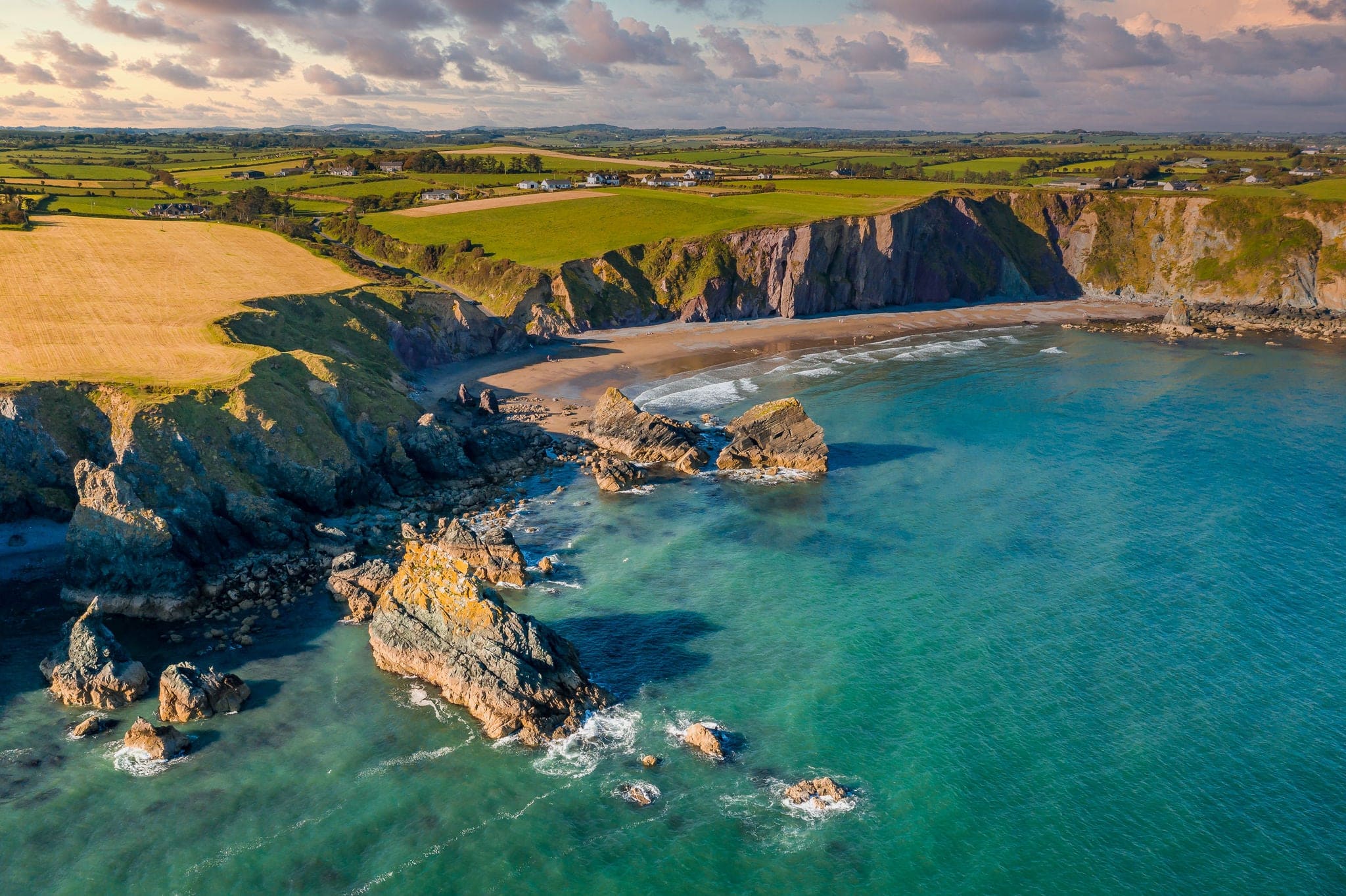 Ballydowane Beach Waterford Ireland, amazing aerial scenery view on cliffs and coast line at sunset