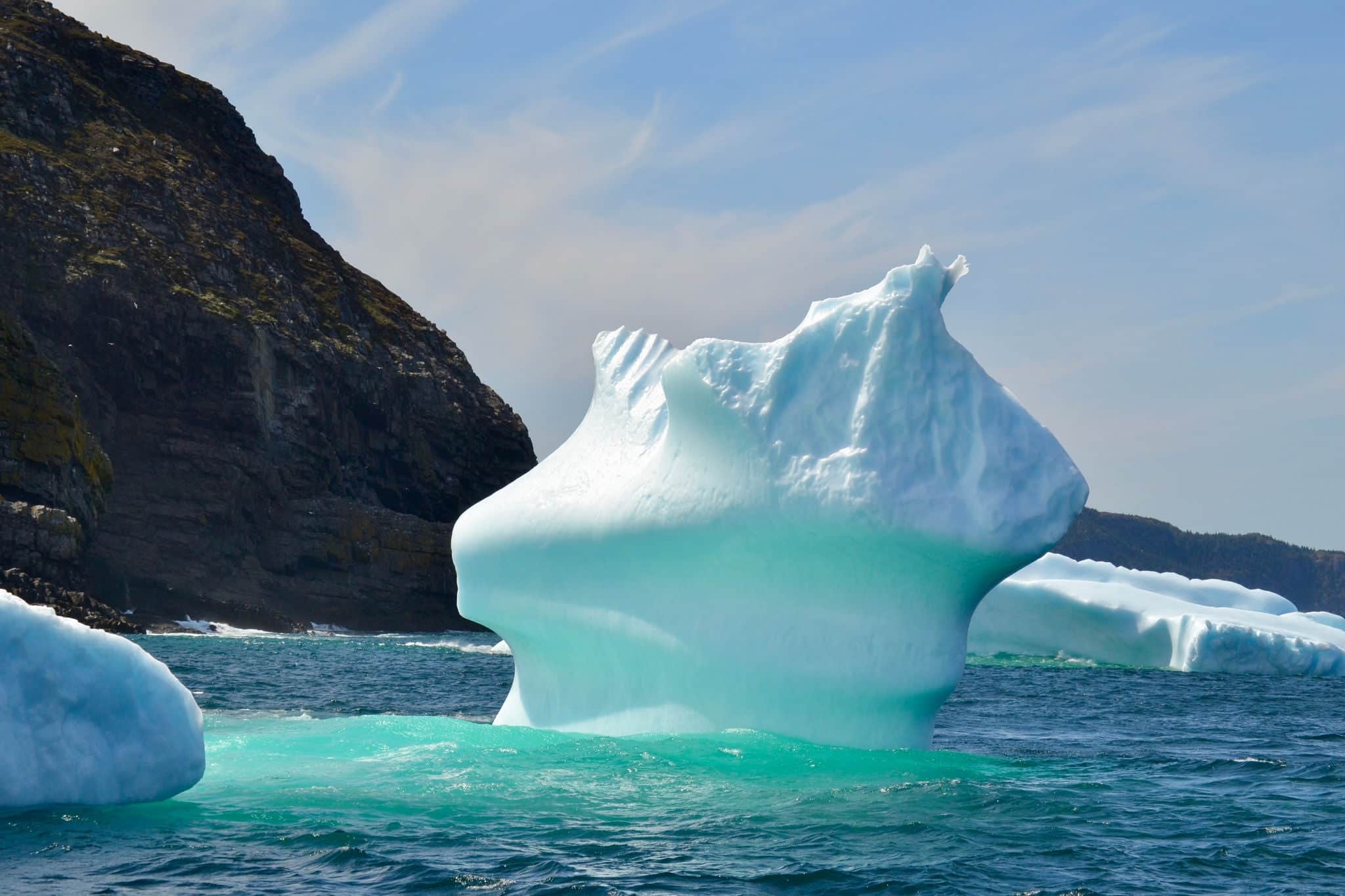 Closeup of iceberg in bay outside St. John's with bright turquoise colouration during Spring