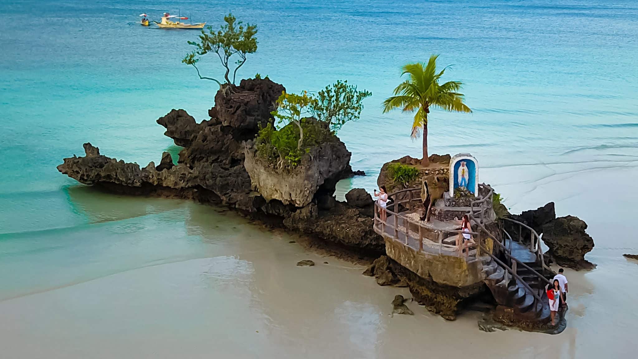 Aerial image of the Willy’s Rock -an oddly shaped volcanic formation with a statue of the Blessed Virgin Mary in Bocaray, Philippine Islands. It is one of the most recognizable landmark of the island