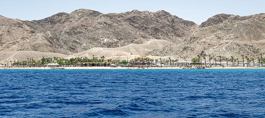 View of Red Sea with rock formations on the distant coast in Sokhna, Egypt.