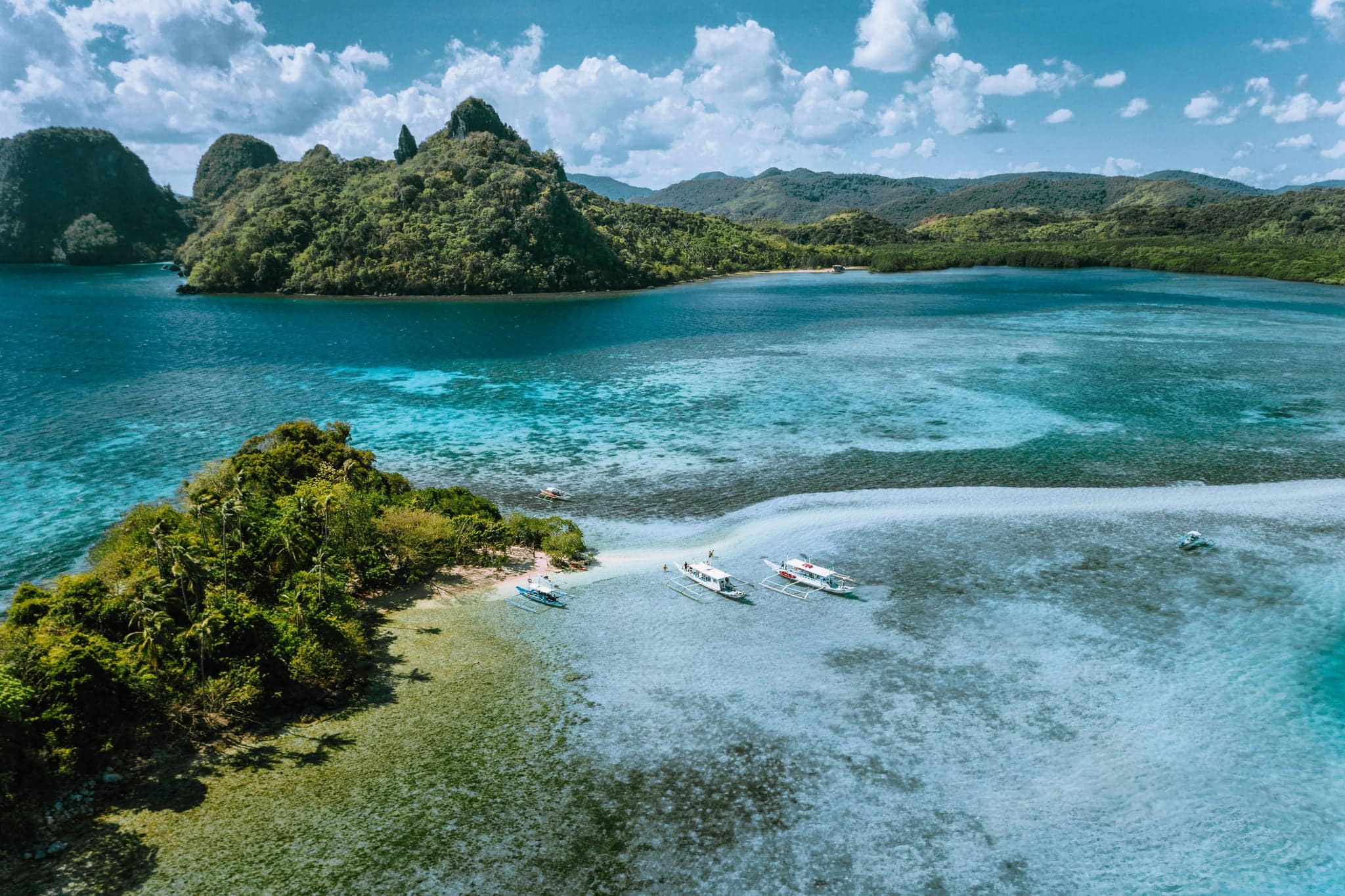 Aerial view of turquoise water and sandbar on tropical Vigan Snake Island, tourist attractions, tour trip El Nido Marine Reserve Park, Philippines