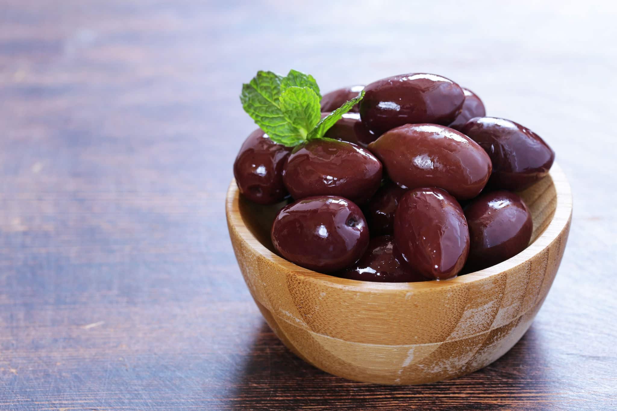 red kalamata olives on a wooden table