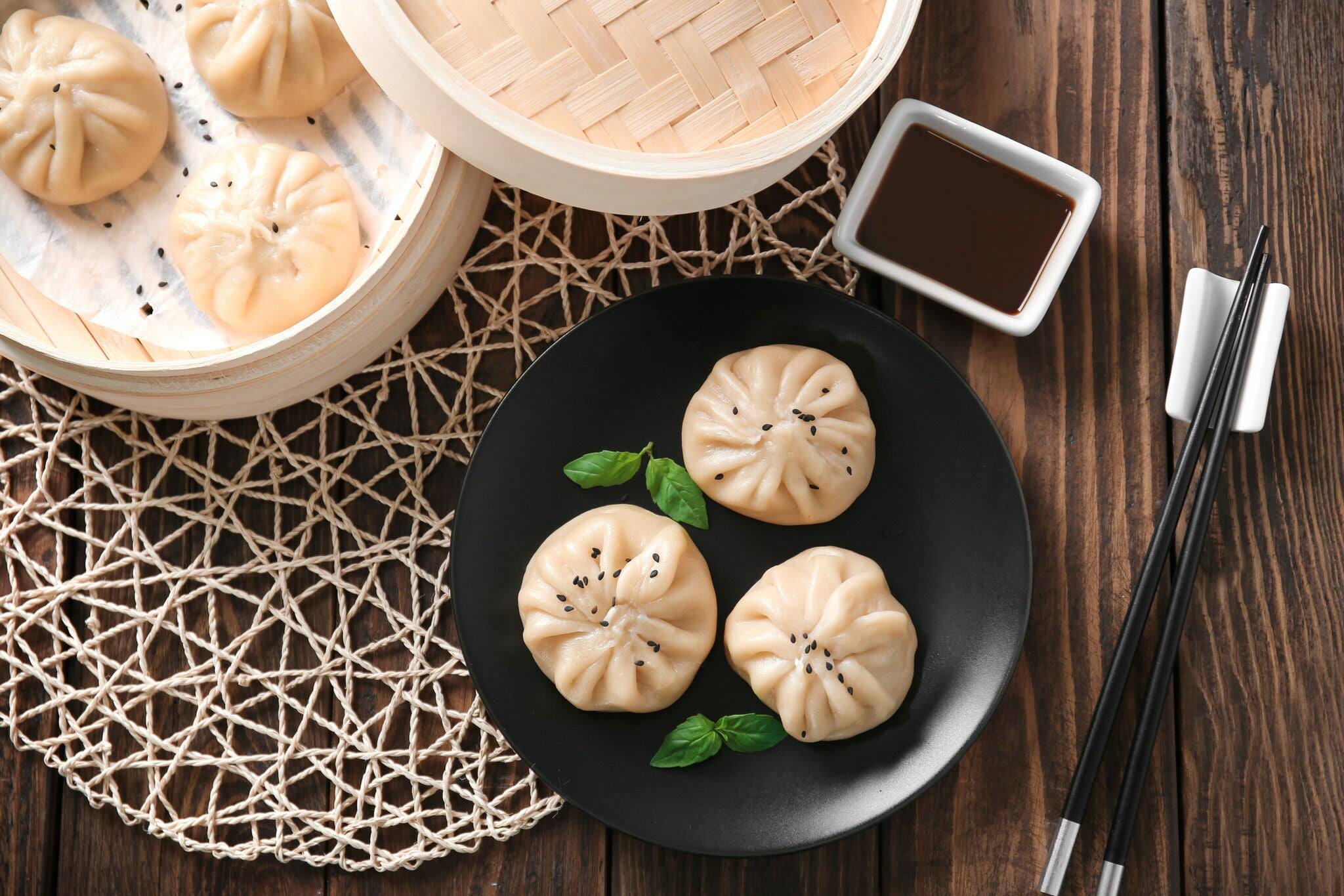 Plate with baozi dumplings on table
