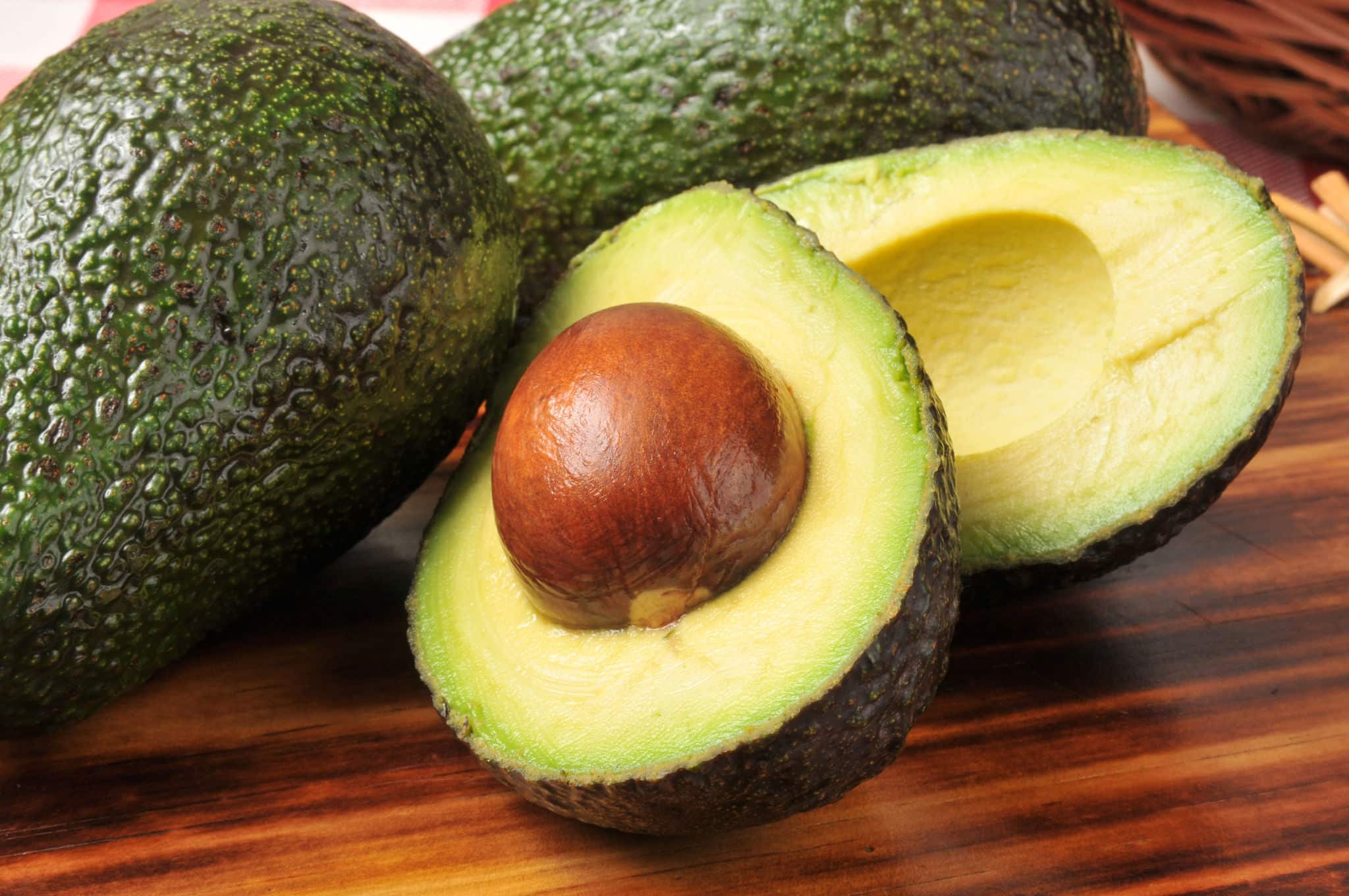 A sliced avocado on a cutting board