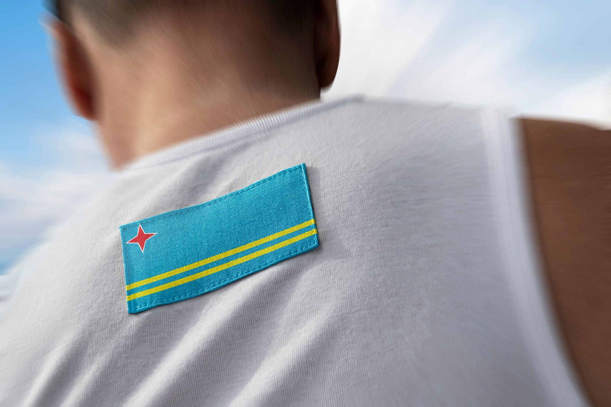 The national flag of Aruba on the athlete's back