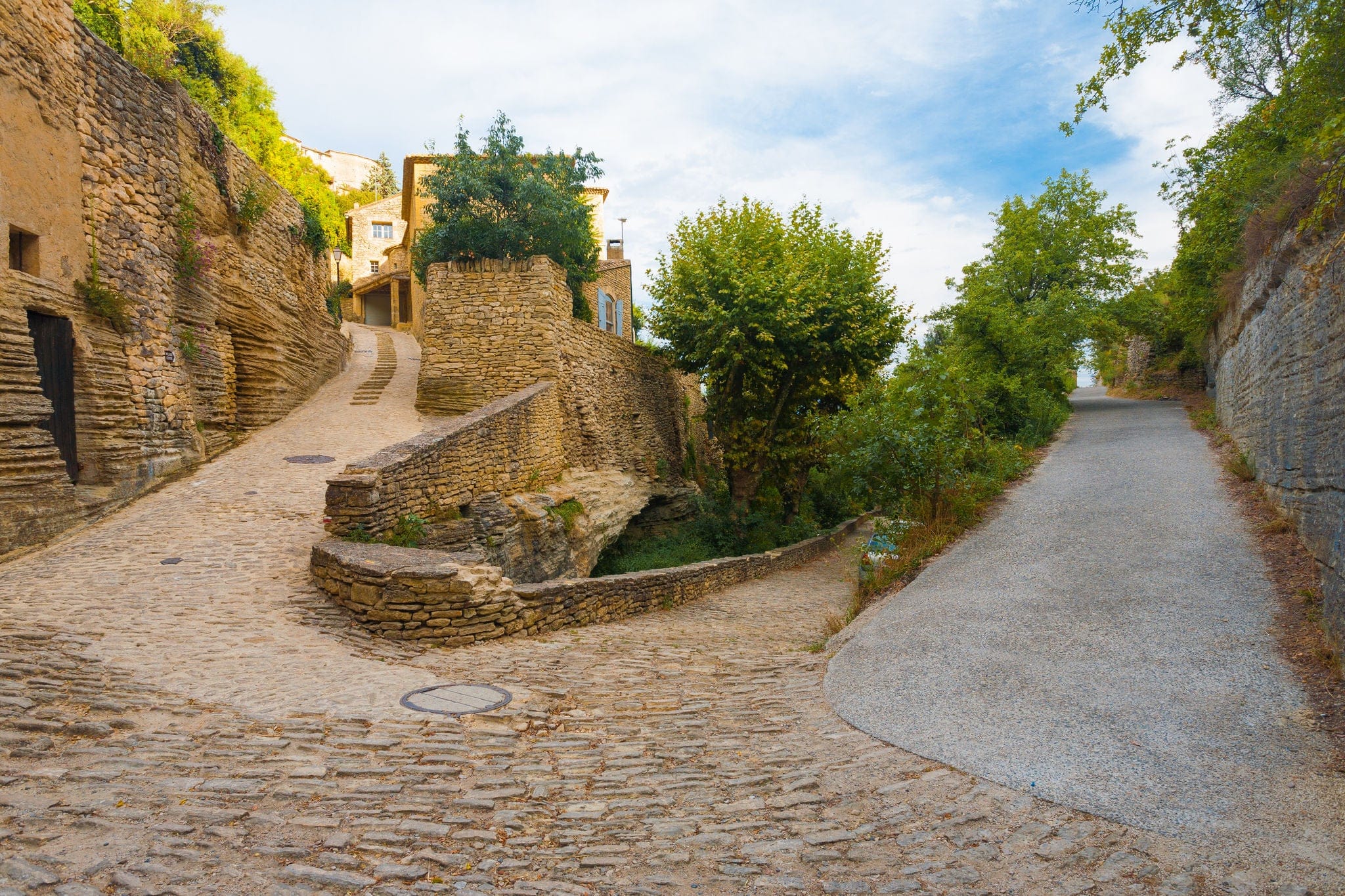 A set of narrow streets at sharp hairpin turn angles in the picturesque medieval village of Gordes, Provence, France