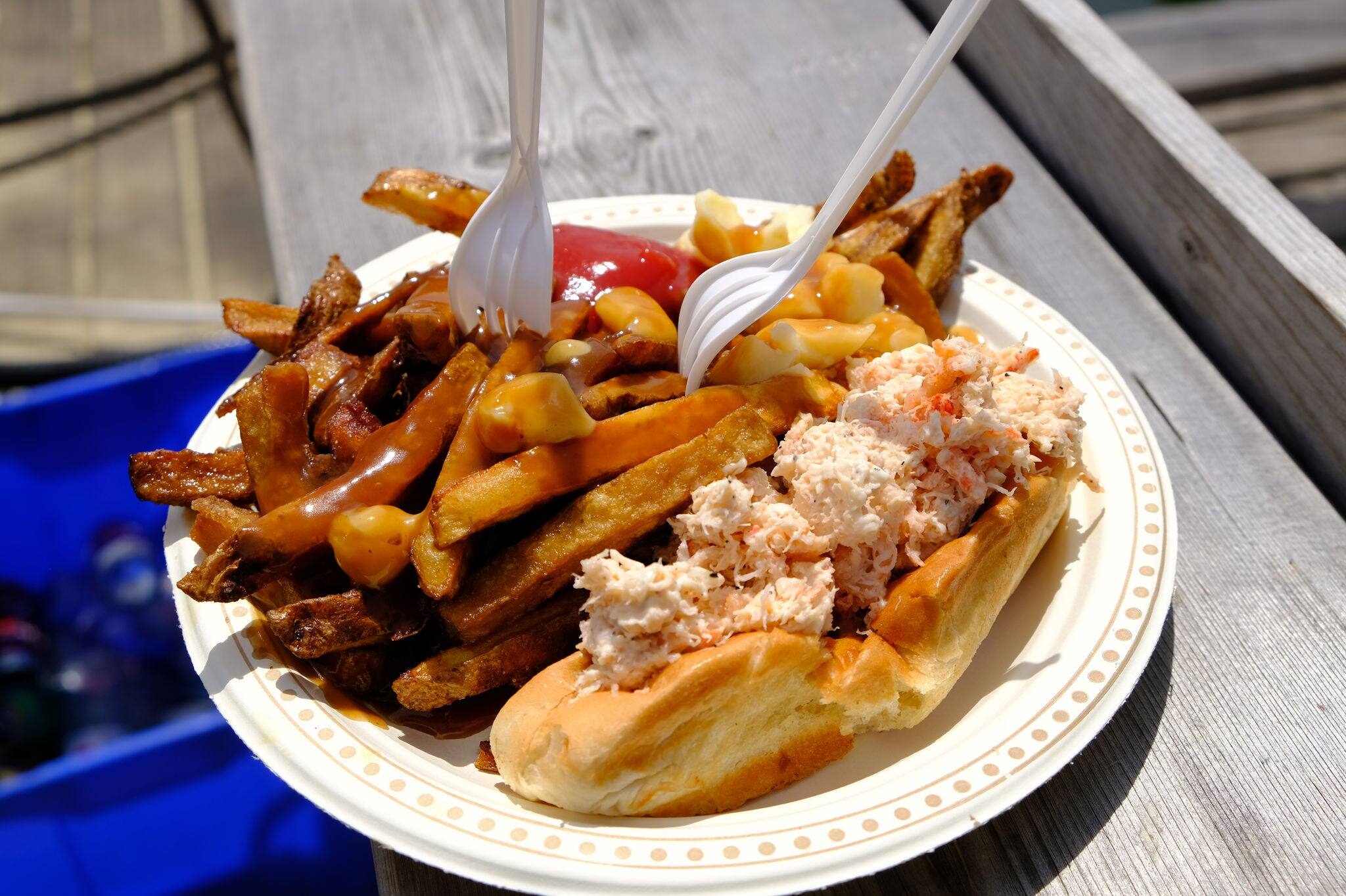Poutine and Lobster rolls combo on a sunny day outdoors