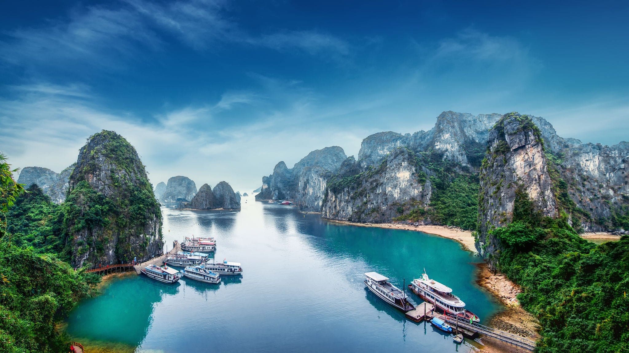 Tourist junks floating among limestone rocks at Ha Long Bay, South China Sea, Vietnam, Southeast Asia