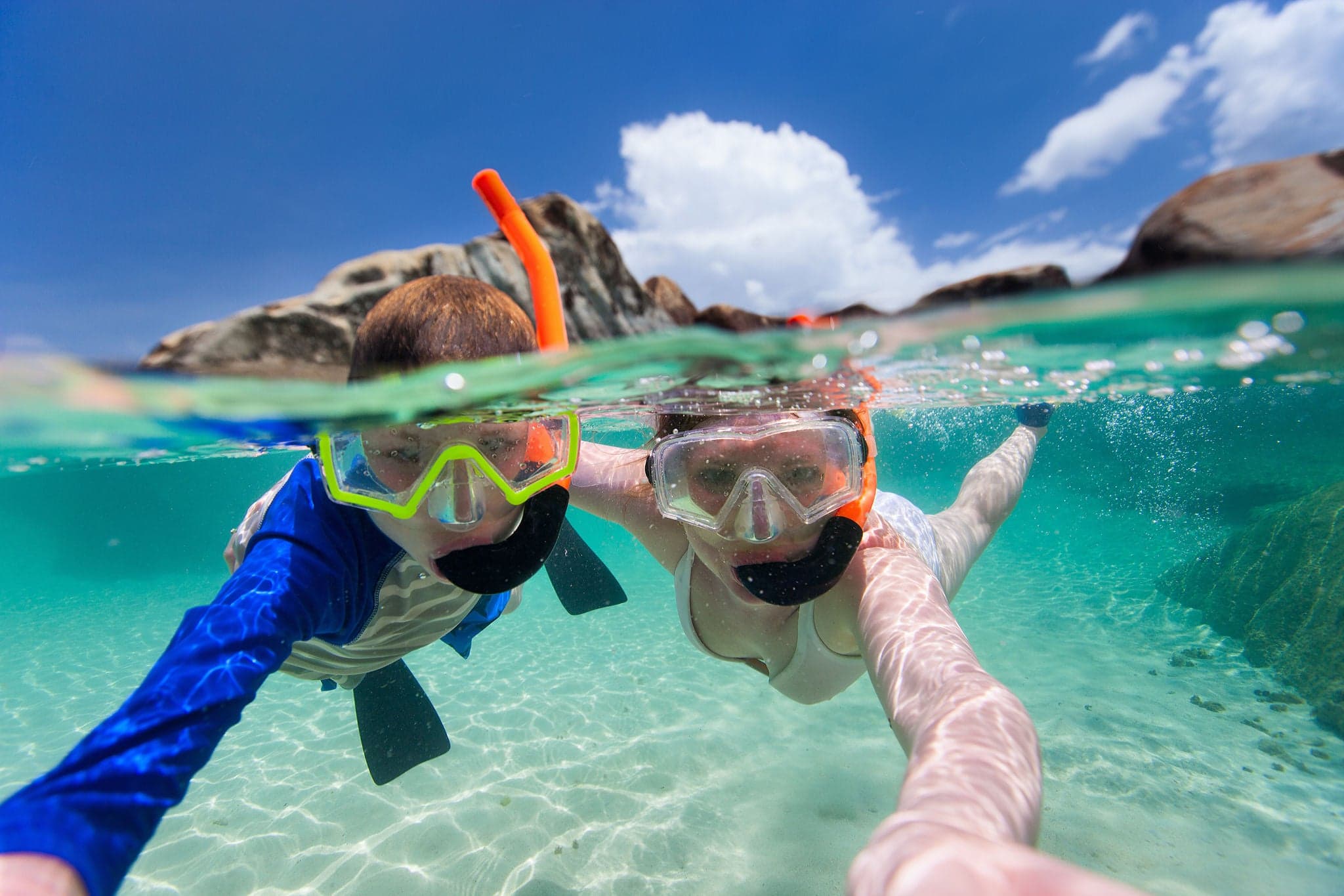Split photo of mother and son family snorkeling in turquoise ocean water at tropical island