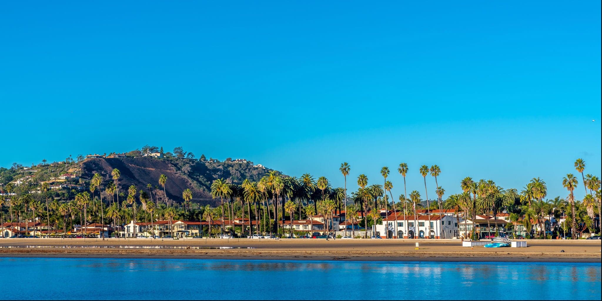 Santa Barbara sandy beach with palm trees and blue sky